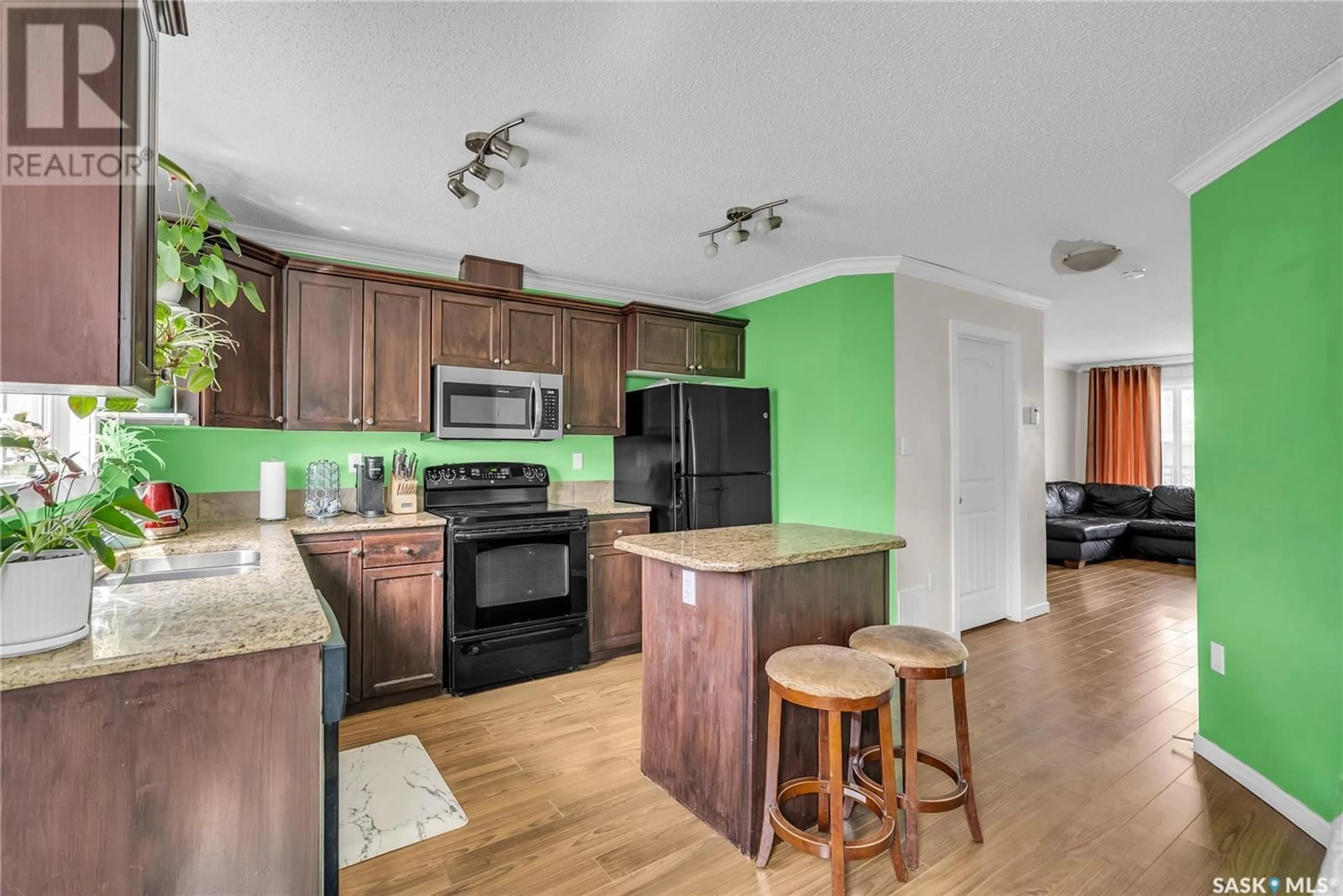 Open concept kitchen, wood/laminate floor for 460 COAD MANOR, Saskatoon Saskatchewan S7R0K2