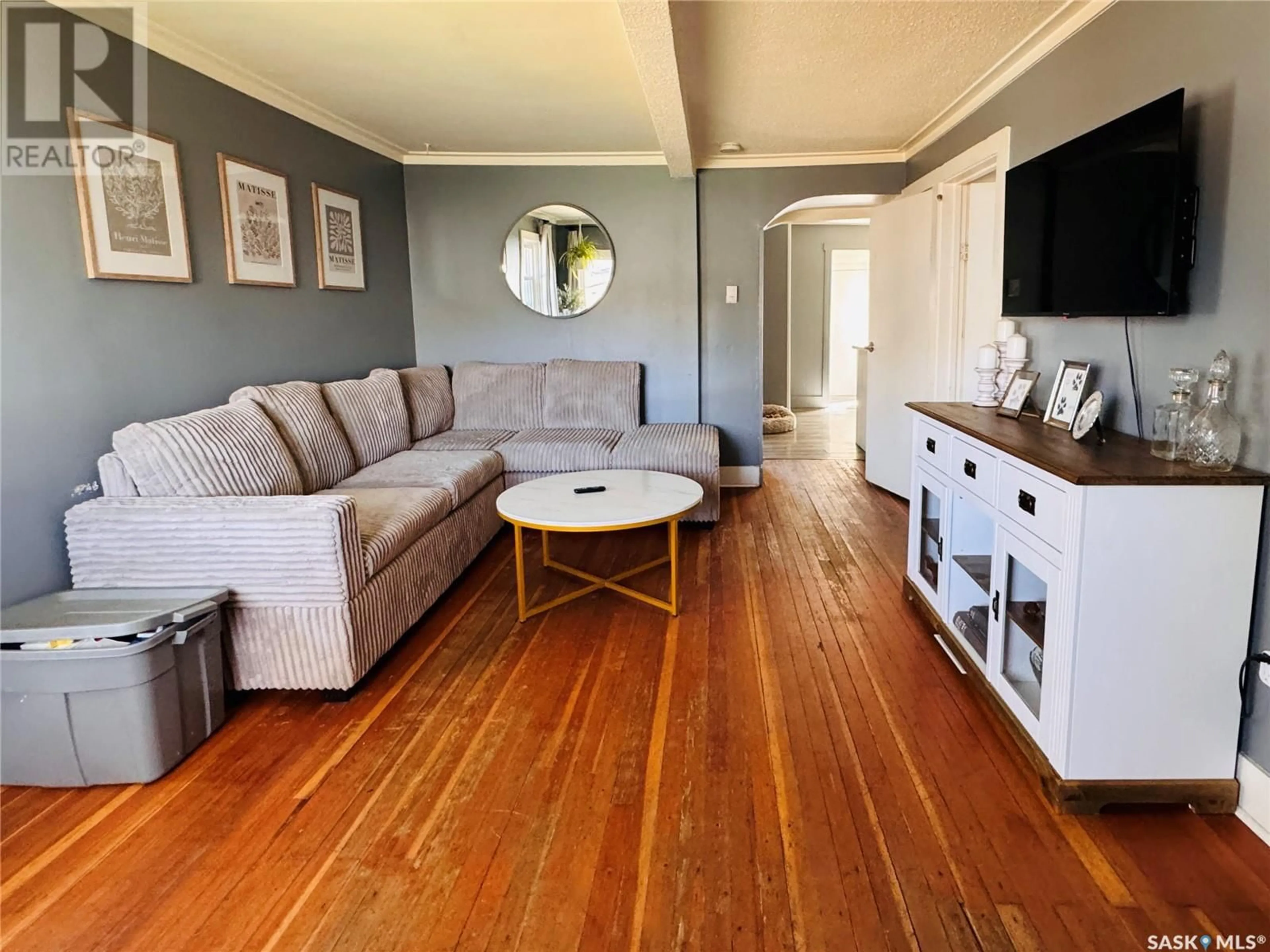 Living room with furniture, wood/laminate floor for 1218 E AVENUE N, Saskatoon Saskatchewan S7L1T4