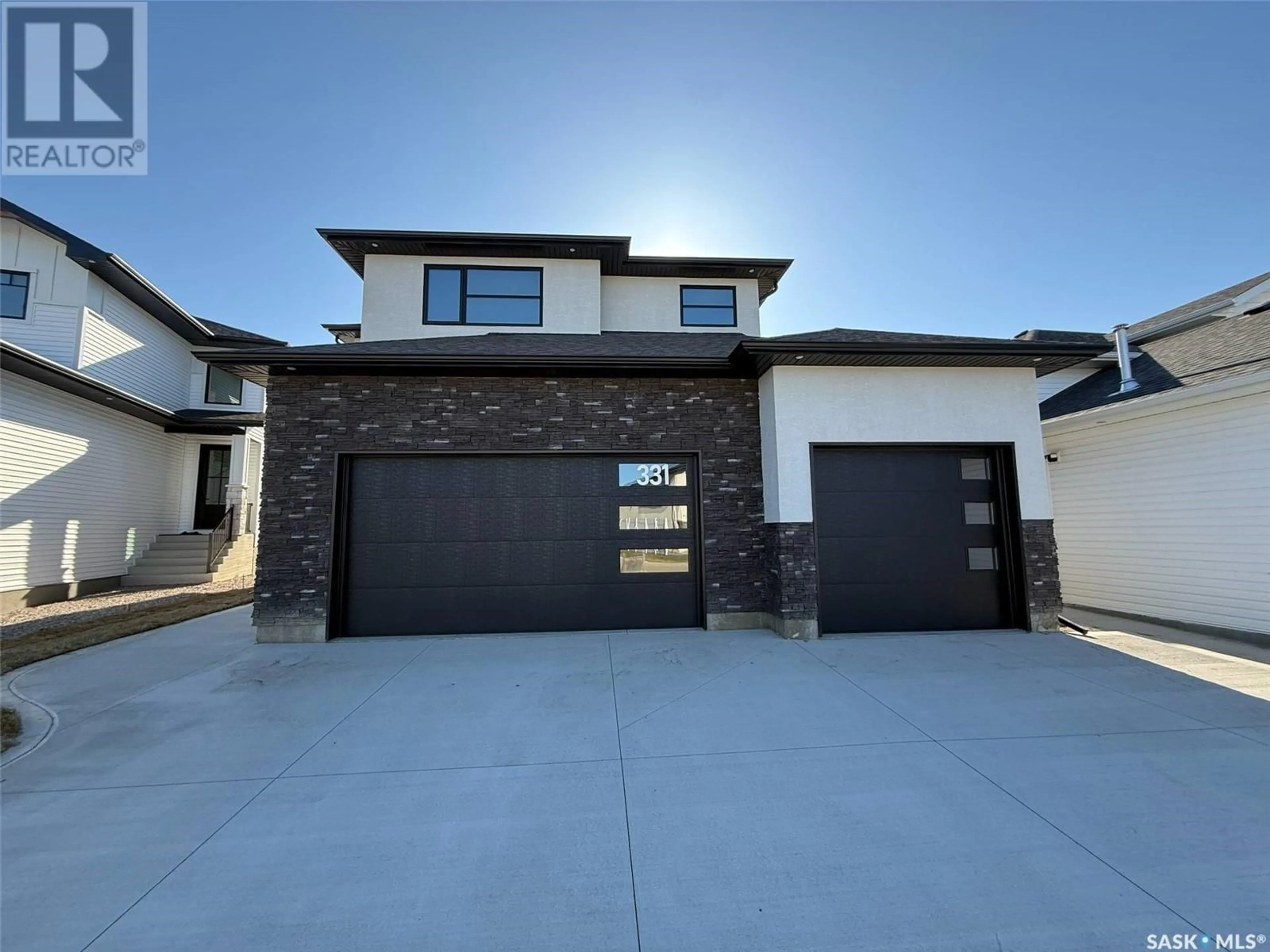Home with brick exterior material, street for 331 WOOLF BAY, Saskatoon Saskatchewan S7W1E5