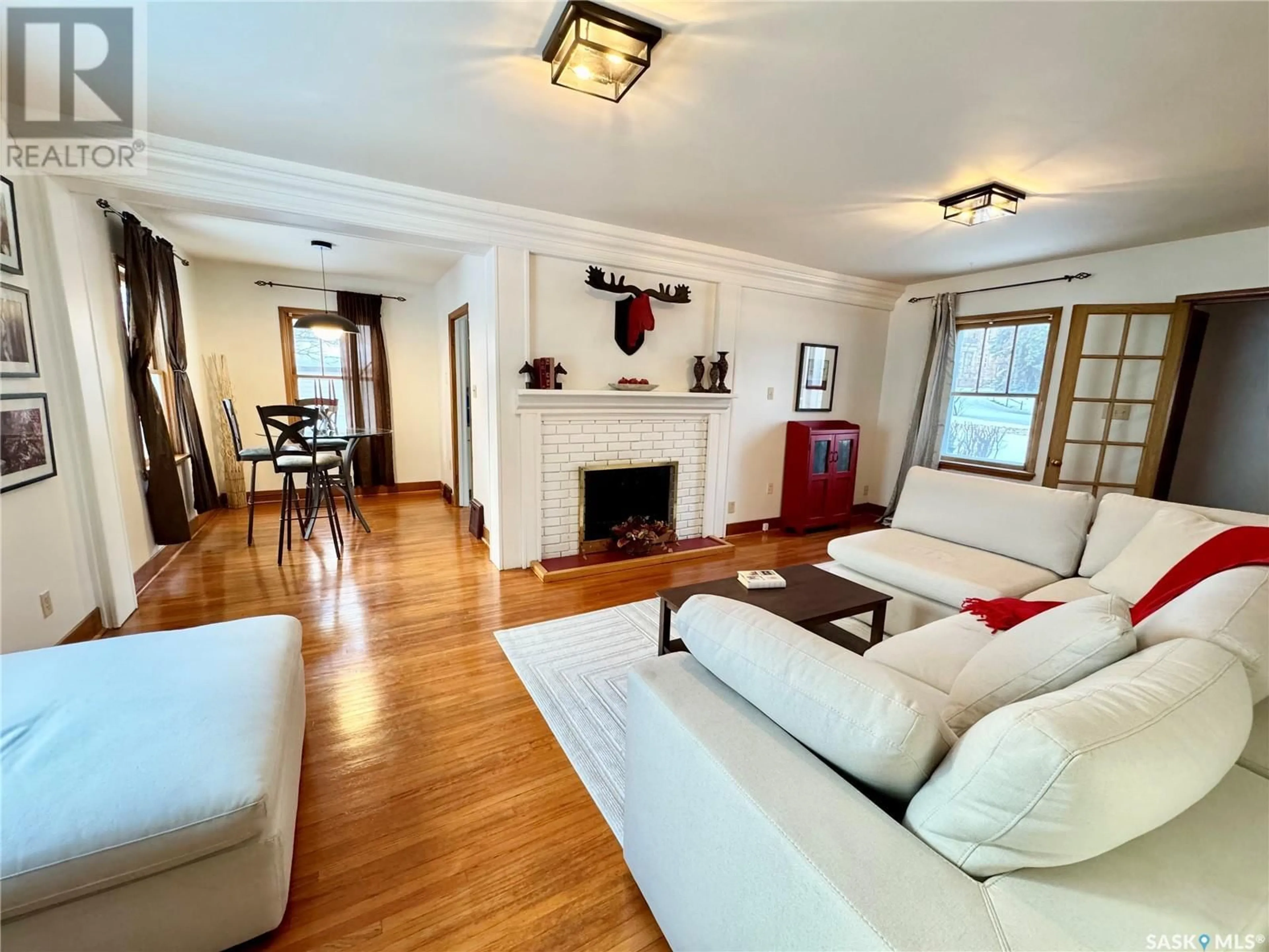 Living room with furniture, wood/laminate floor for 1810 CENTRAL AVENUE, Prince Albert Saskatchewan S6V4W9
