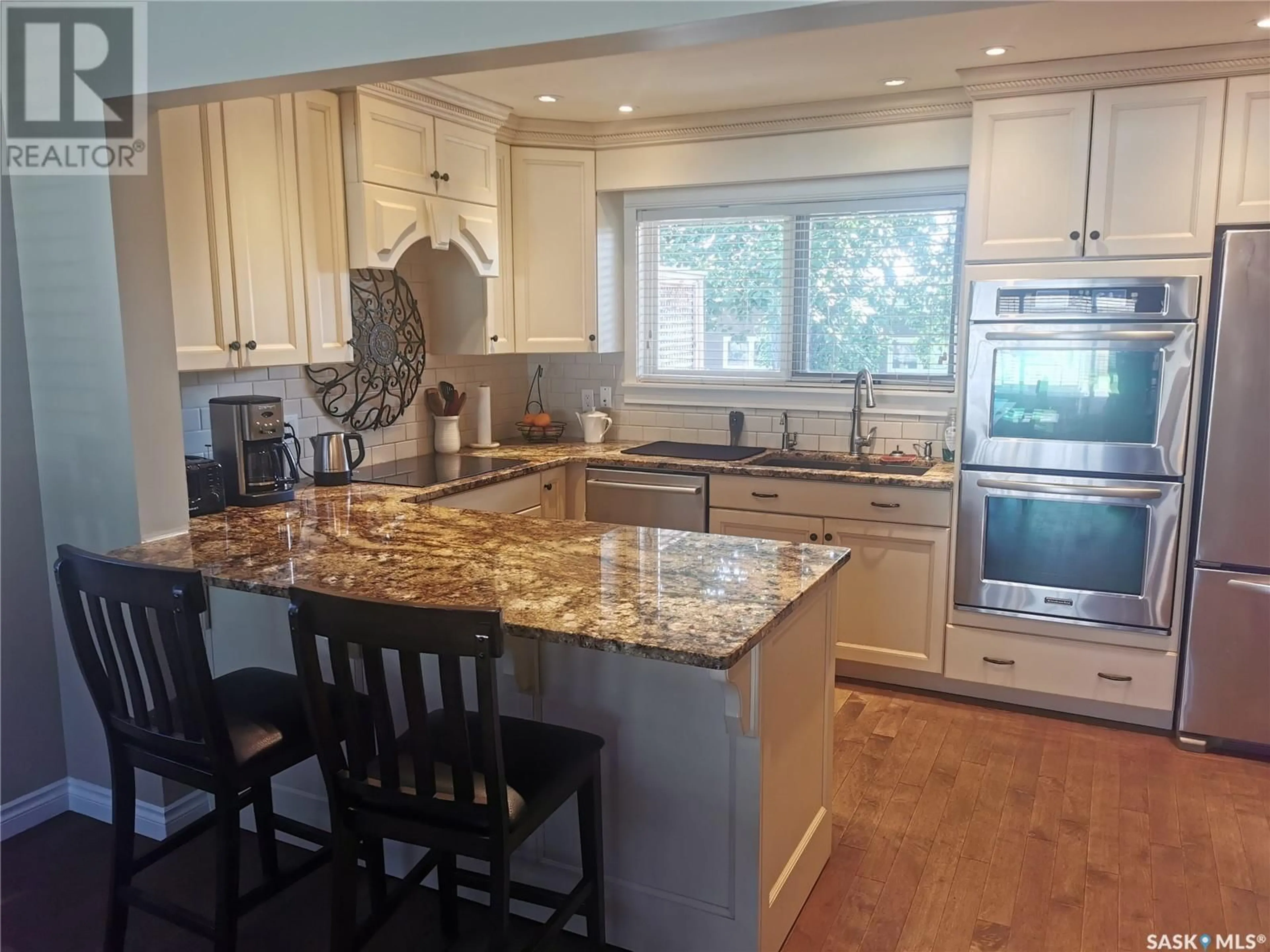 Open concept kitchen, wood/laminate floor for 314 DORE WAY, Saskatoon Saskatchewan S7K4X9