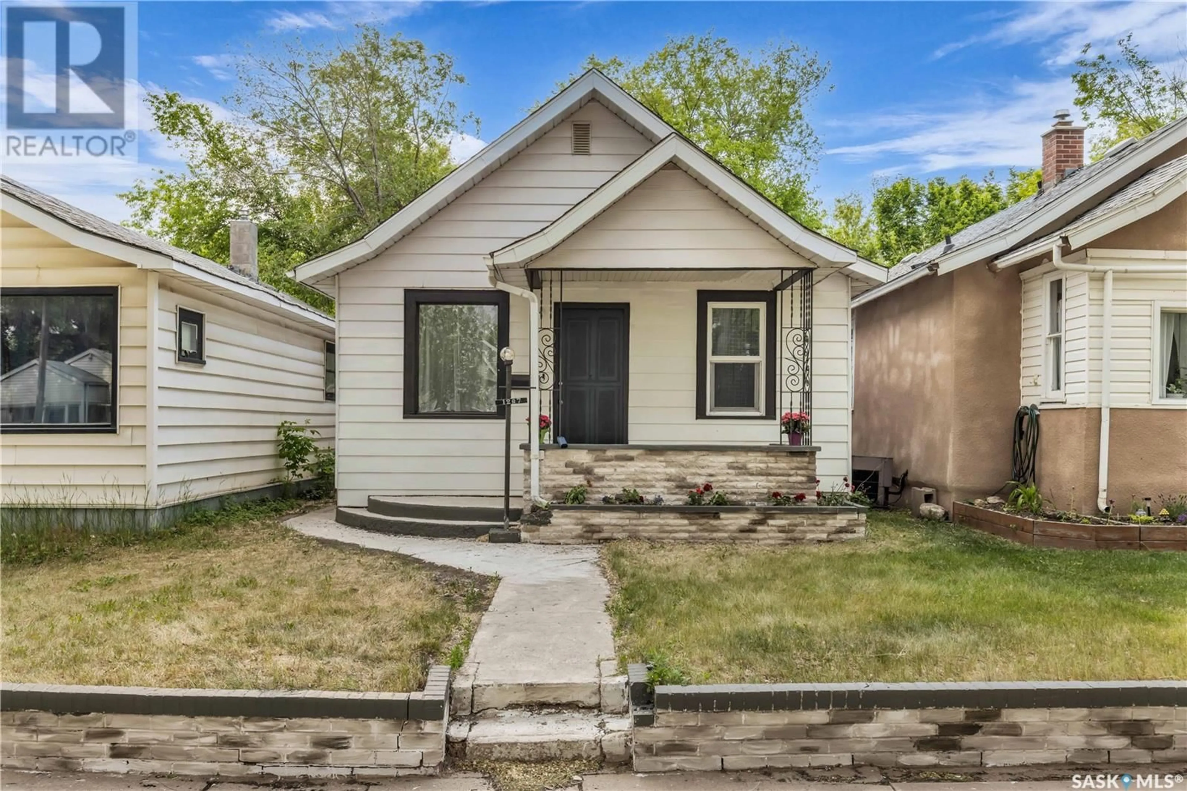 Home with vinyl exterior material, street for 1227 C AVENUE, Saskatoon Saskatchewan S7K1L6