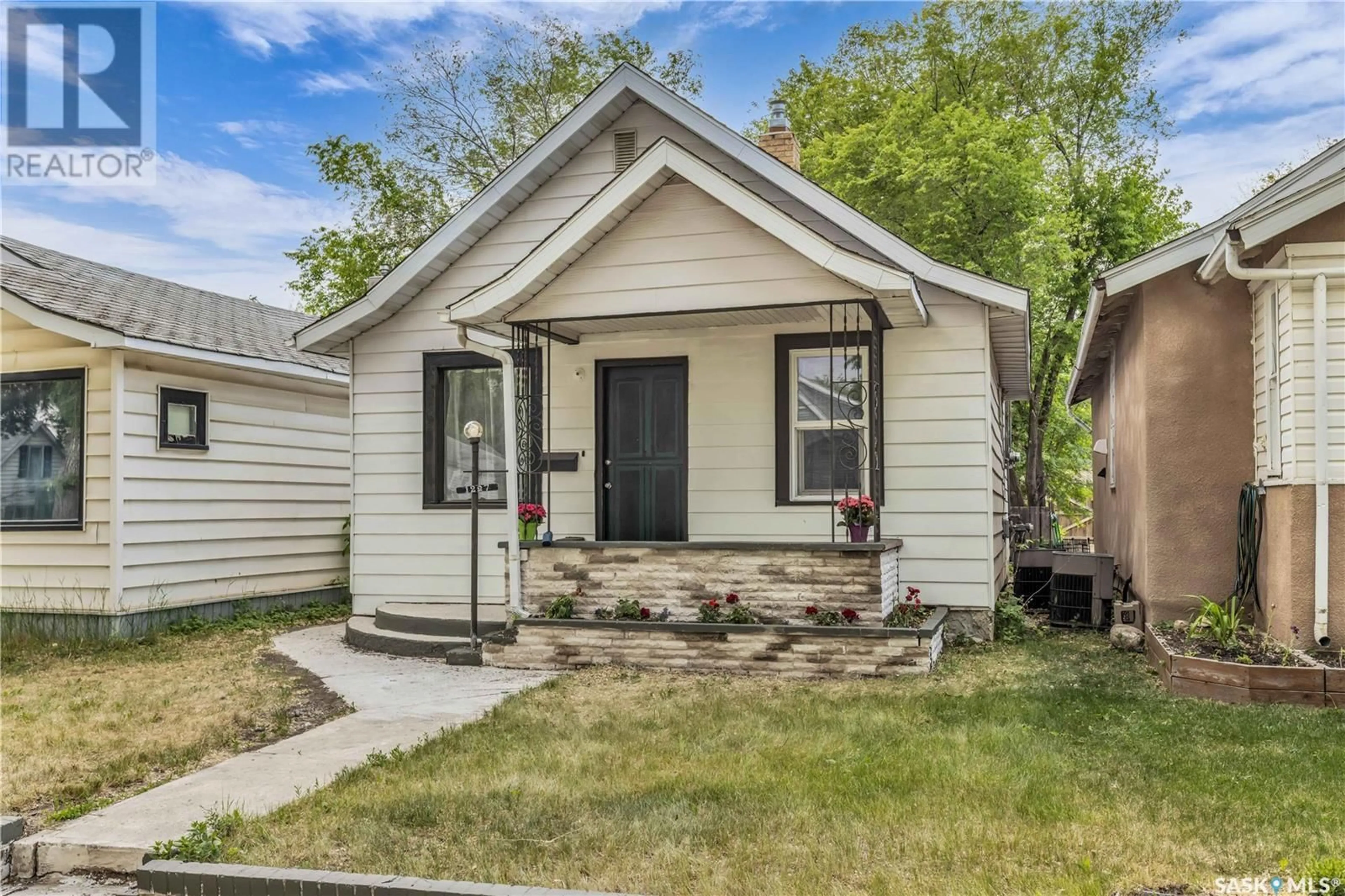 Home with vinyl exterior material, street for 1227 C AVENUE, Saskatoon Saskatchewan S7K1L6