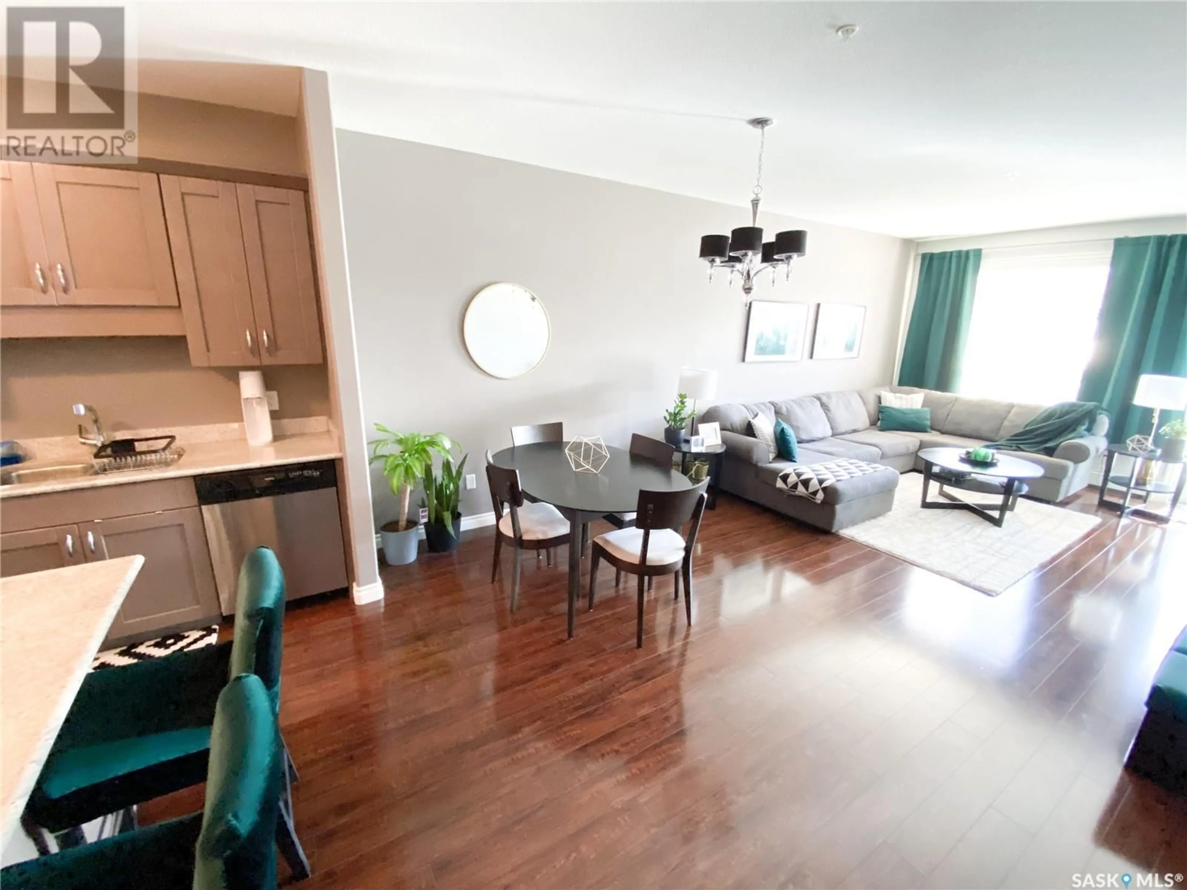 Living room with furniture, wood/laminate floor for 110 2730 MAIN STREET, Saskatoon Saskatchewan S7H0M3