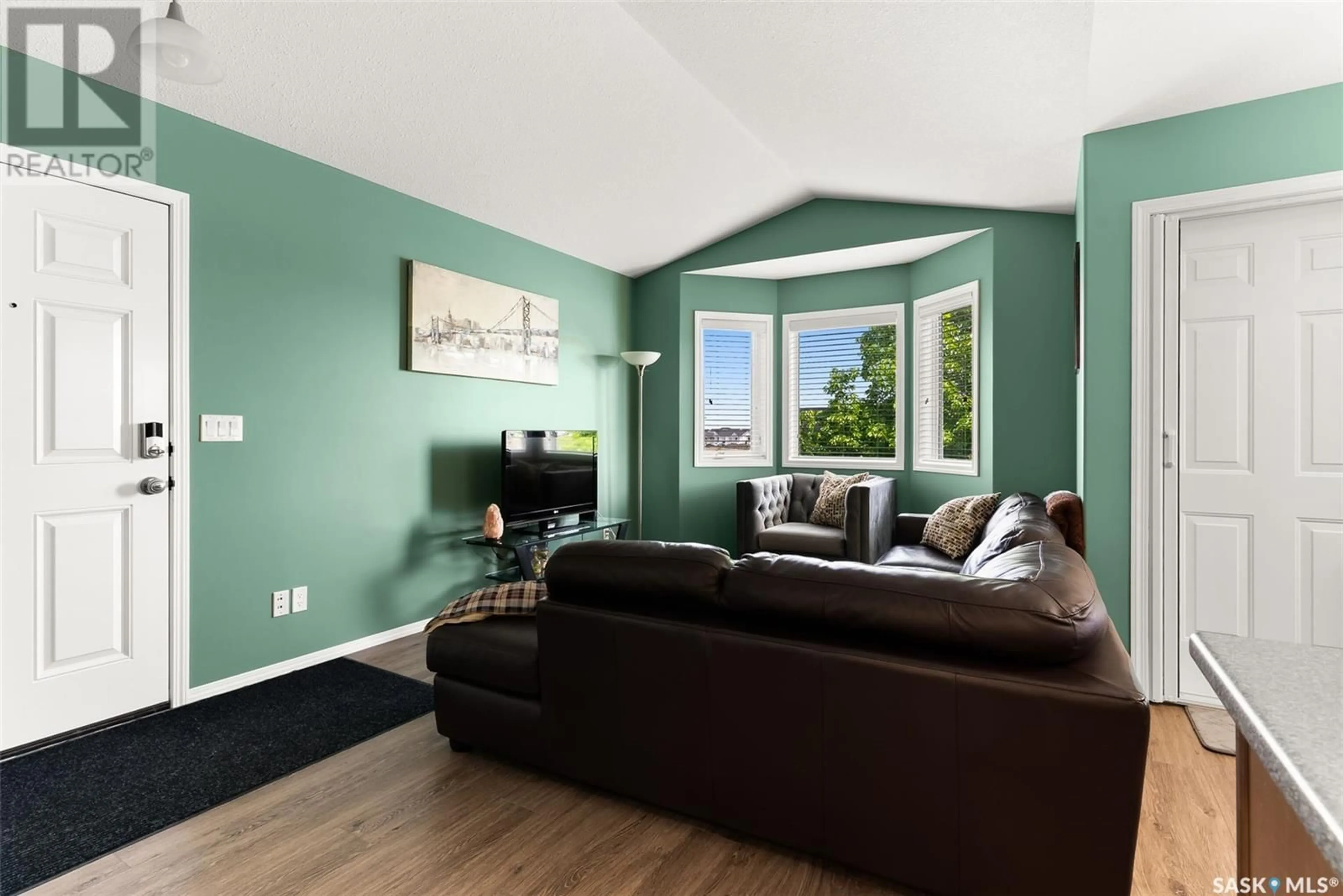 Living room with furniture, wood/laminate floor for 4156 BUCKINGHAM DRIVE, Regina Saskatchewan S4V3A9