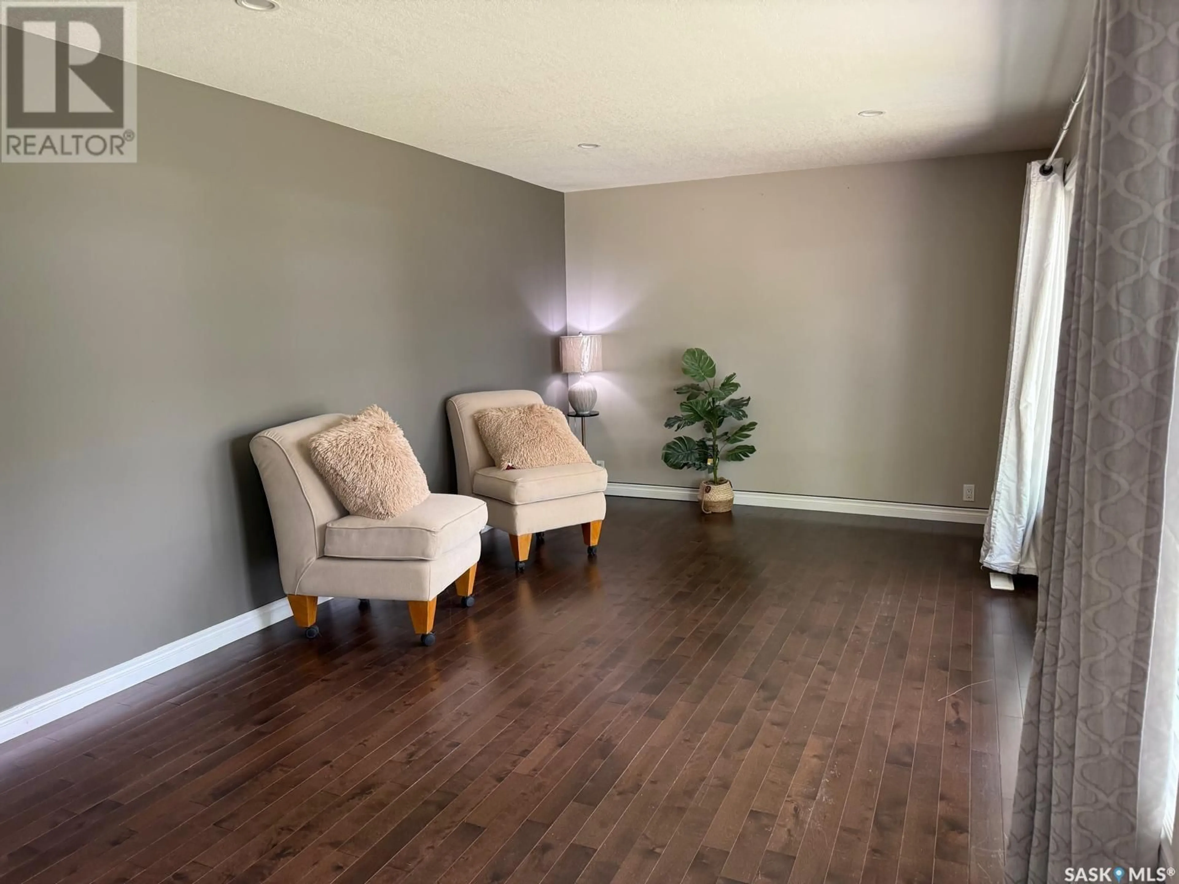 Living room with furniture, wood/laminate floor for 10 MCNAB CRESCENT, Regina Saskatchewan S4S4B1