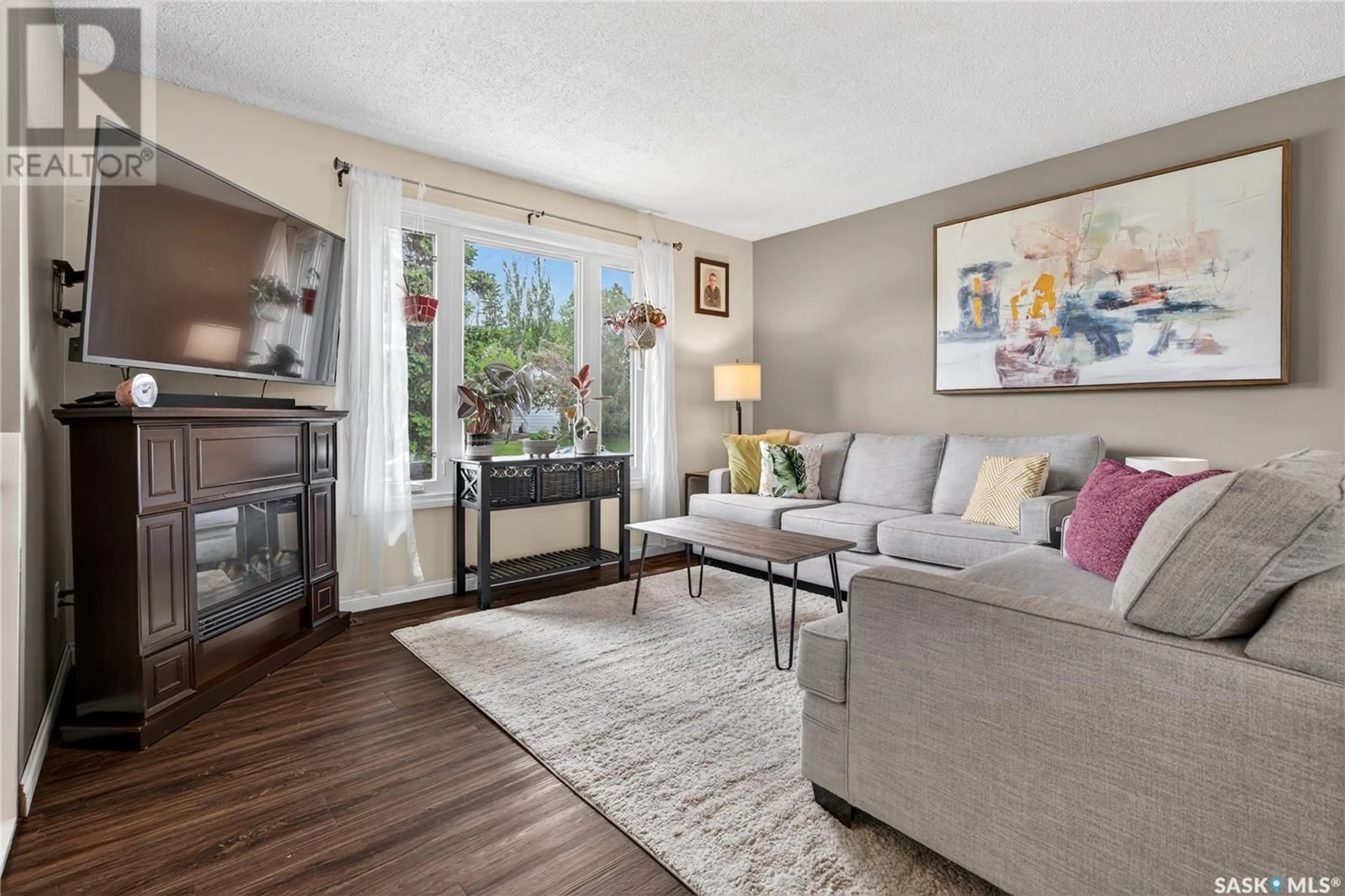 Living room with furniture, wood/laminate floor for 1514 VAUGHAN STREET, Moose Jaw Saskatchewan S6H6S8