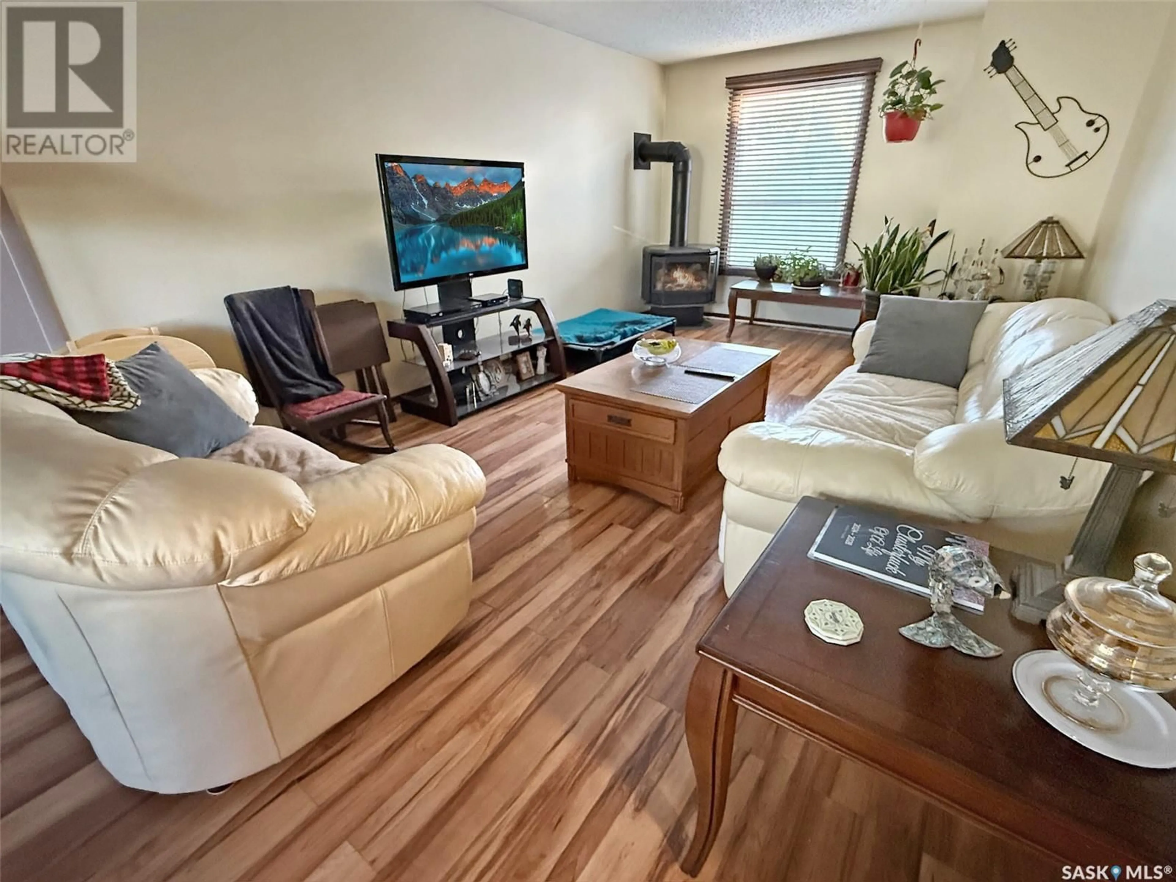 Living room with furniture, wood/laminate floor for 428 1ST AVENUE, Swift Current Saskatchewan S9H0N4