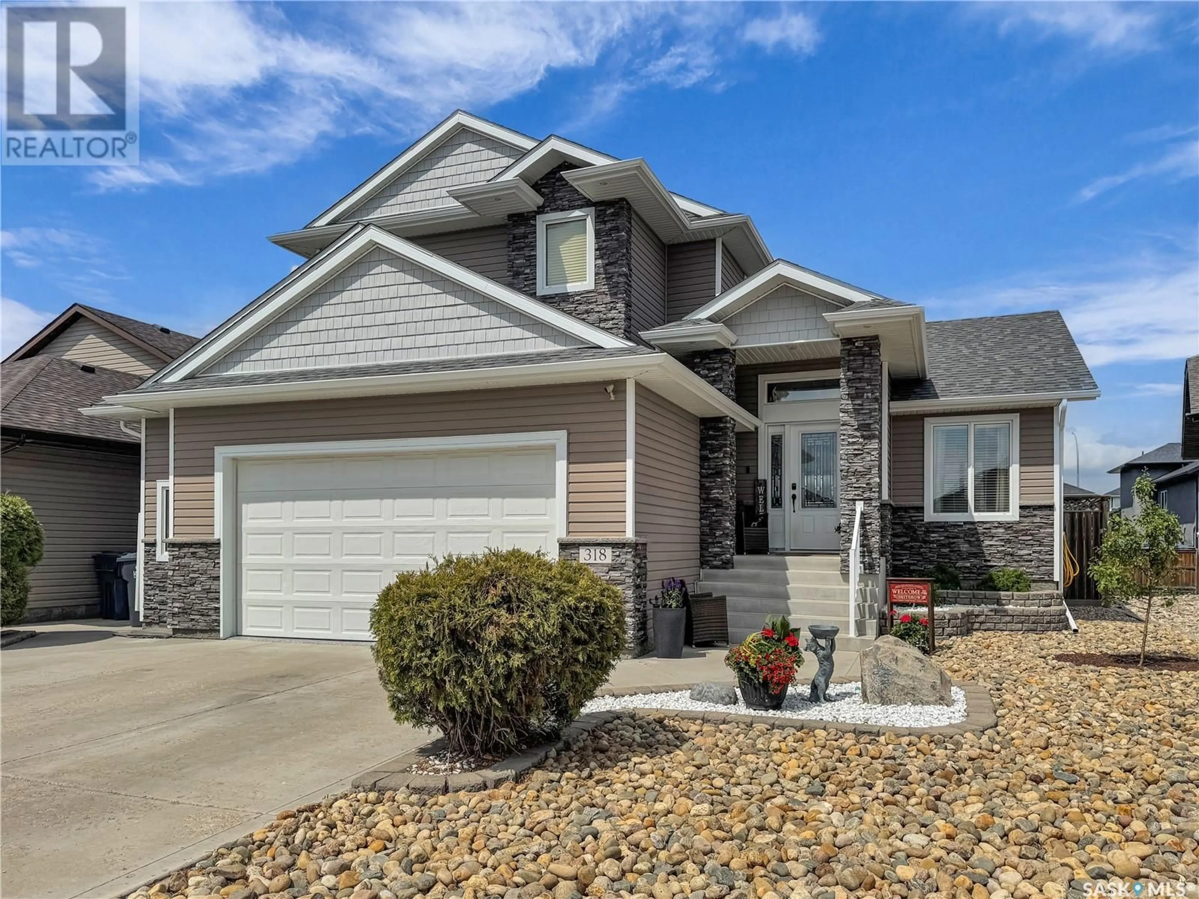 Home with vinyl exterior material, street for 318 LAKERIDGE DRIVE, Warman Saskatchewan S0K0A1