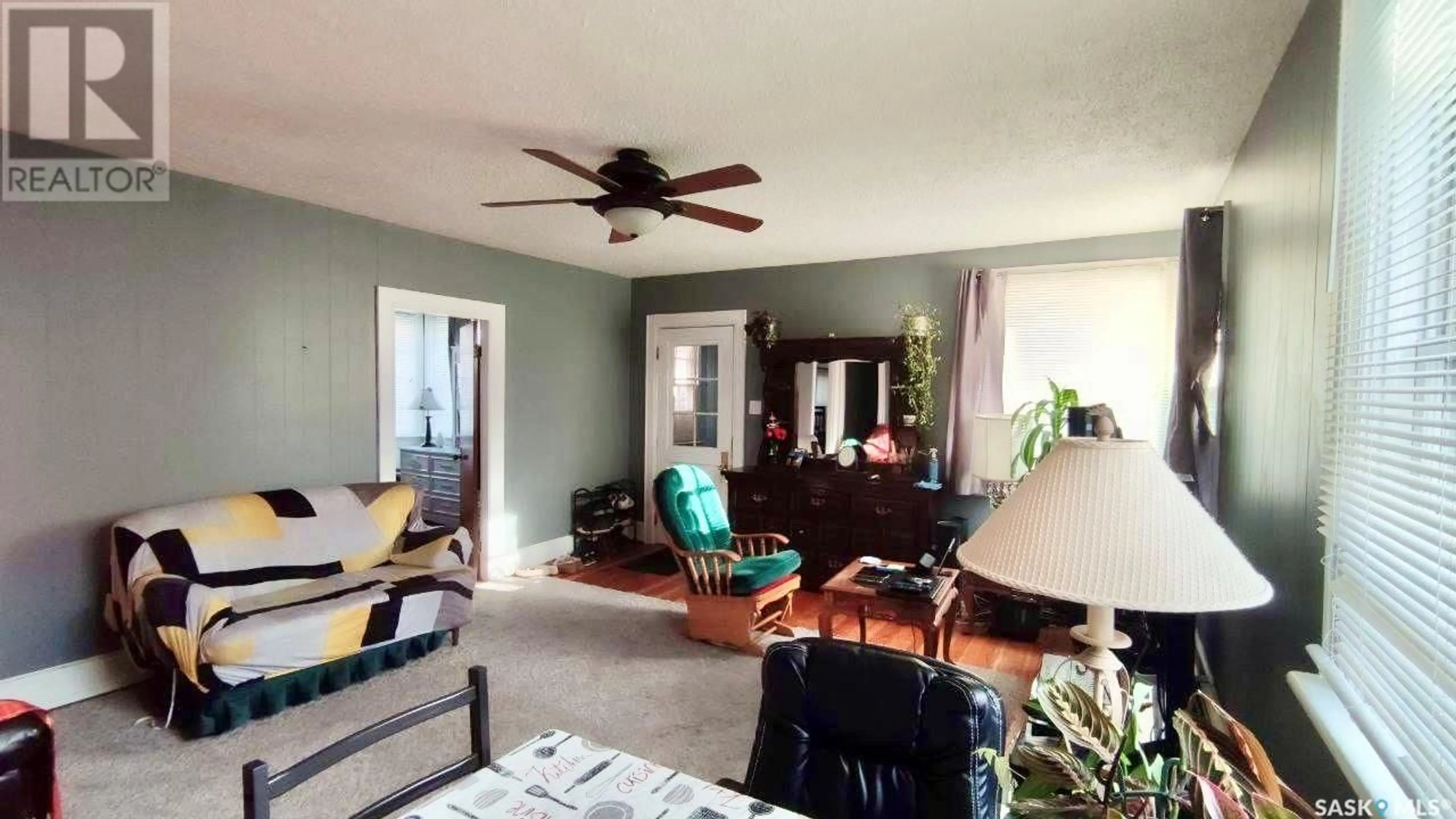 Living room with furniture, wood/laminate floor for 1341 105TH STREET, North Battleford Saskatchewan S9A1T1