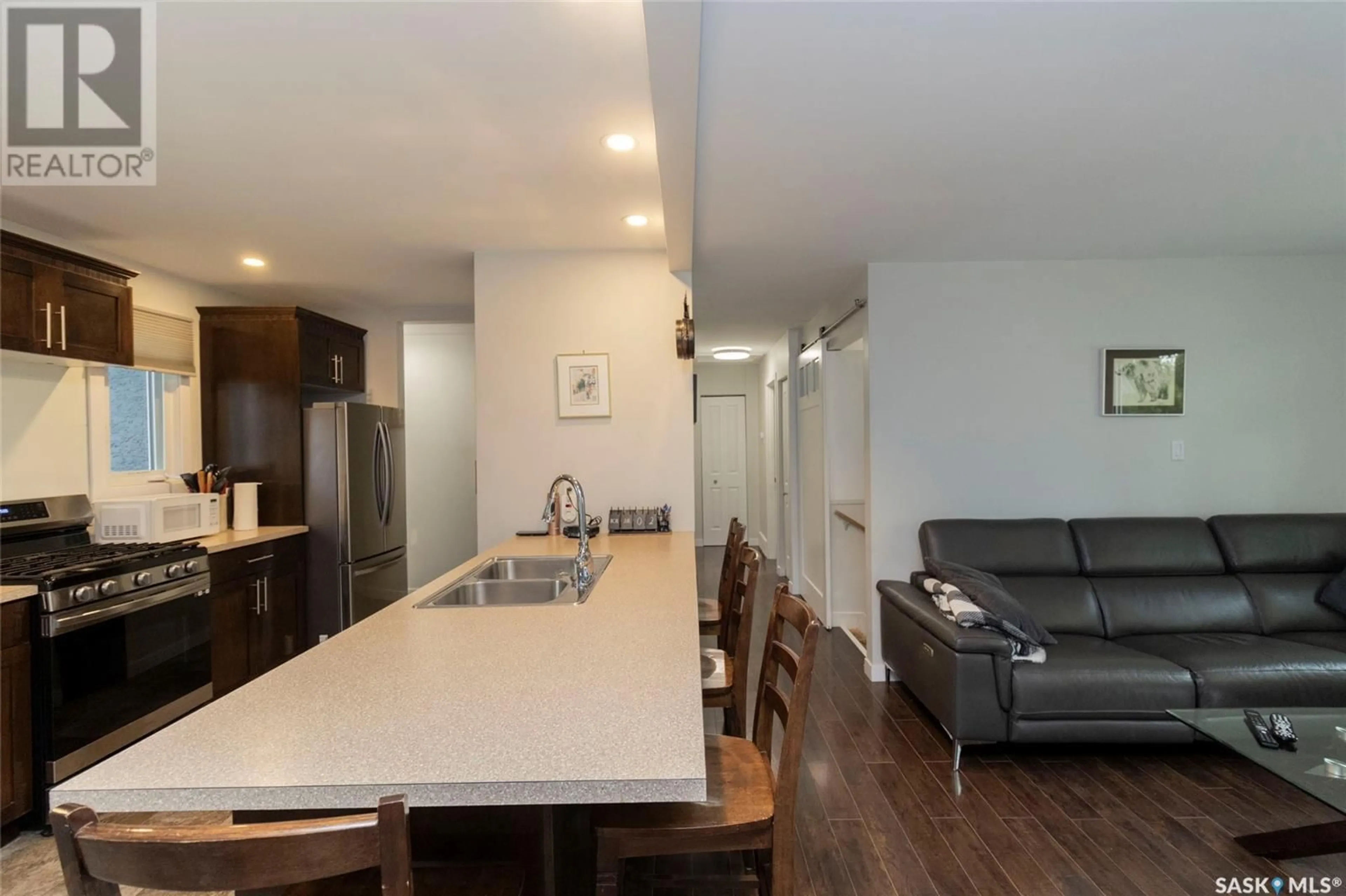 Open concept kitchen, wood/laminate floor for 15 SELKIRK CRESCENT, Saskatoon Saskatchewan S7L4J4