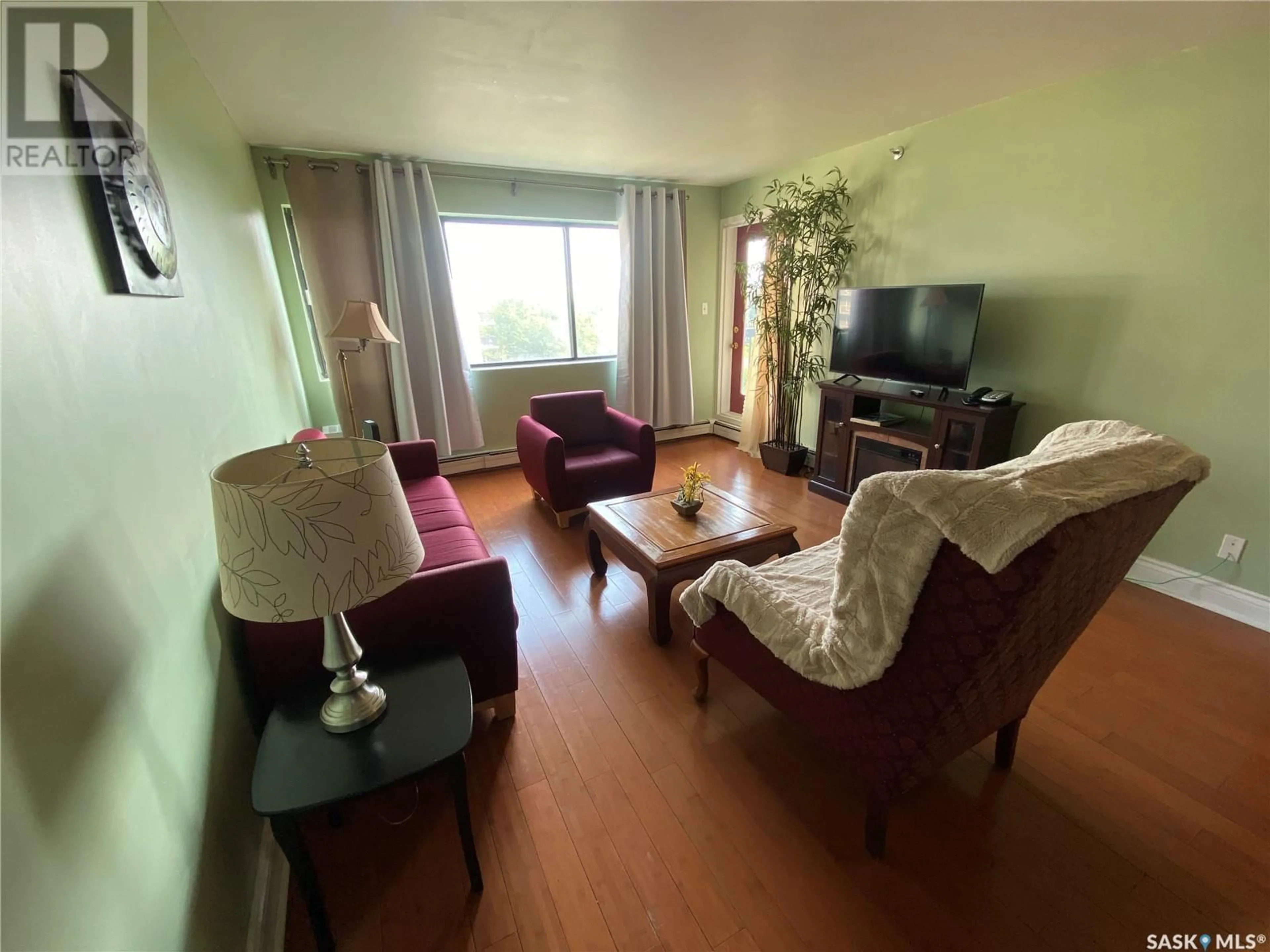 Living room with furniture, wood/laminate floor for N - 703 311 6TH AVENUE, Saskatoon Saskatchewan S7K7A9