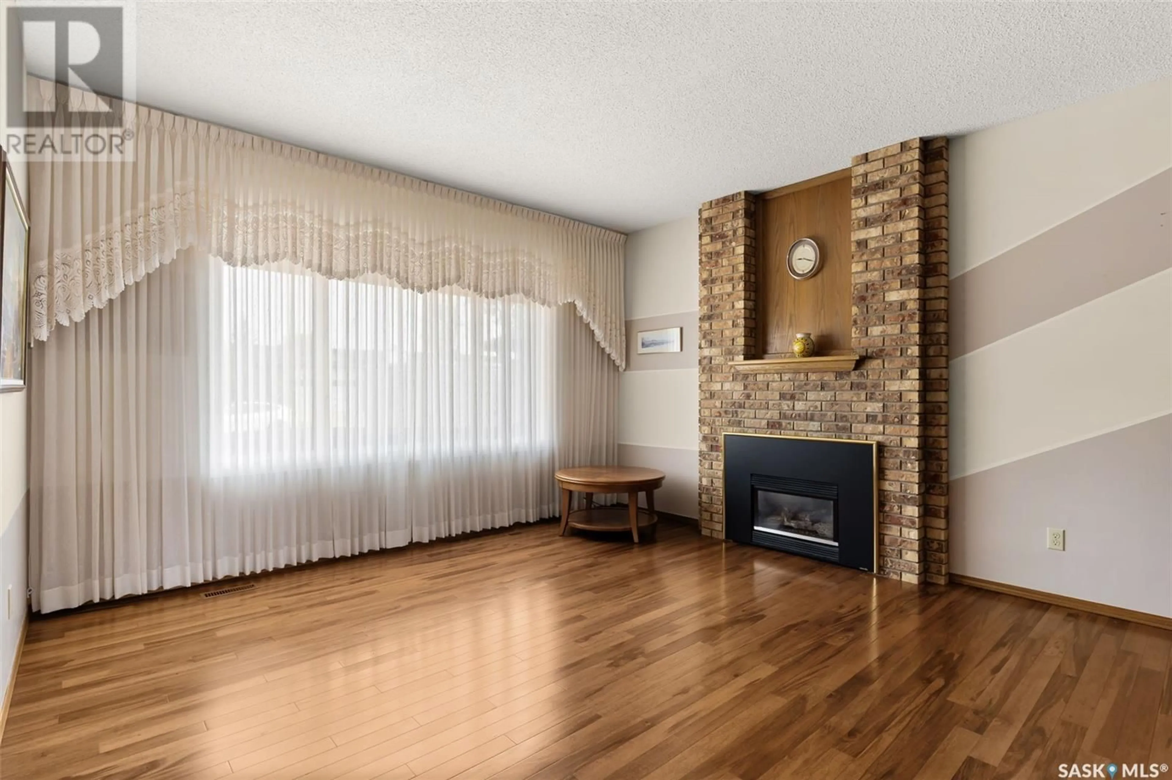 Living room with furniture, wood/laminate floor for 3211 CARNEGIE STREET, Regina Saskatchewan S4R8J4