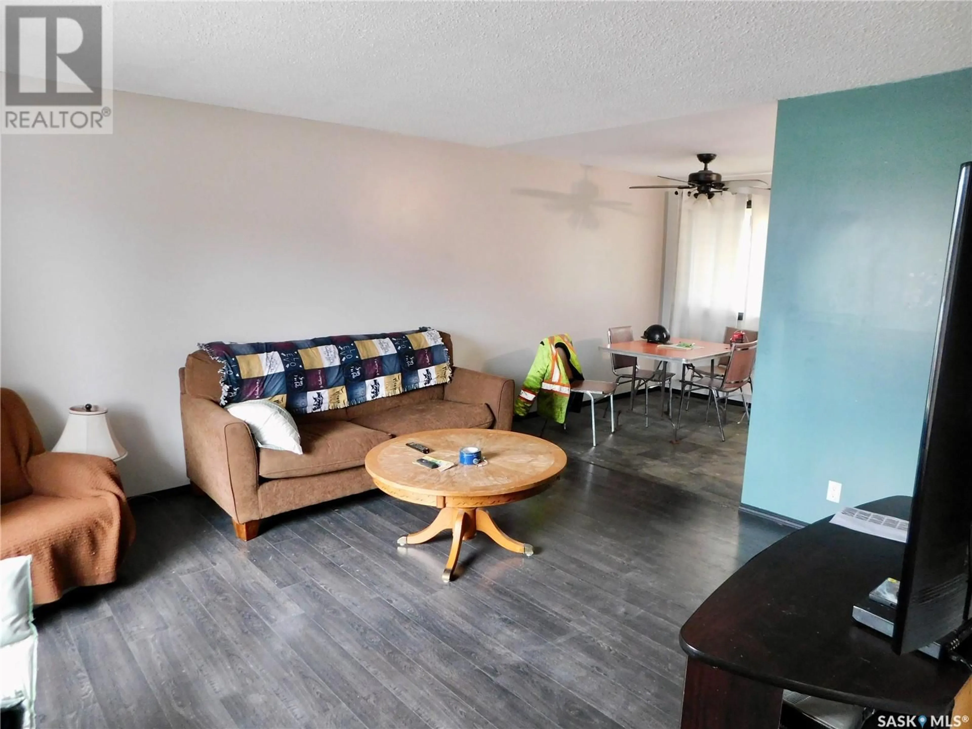 Living room with furniture, wood/laminate floor for 606 LEEVILLE DRIVE, Assiniboia Saskatchewan S0H0B0