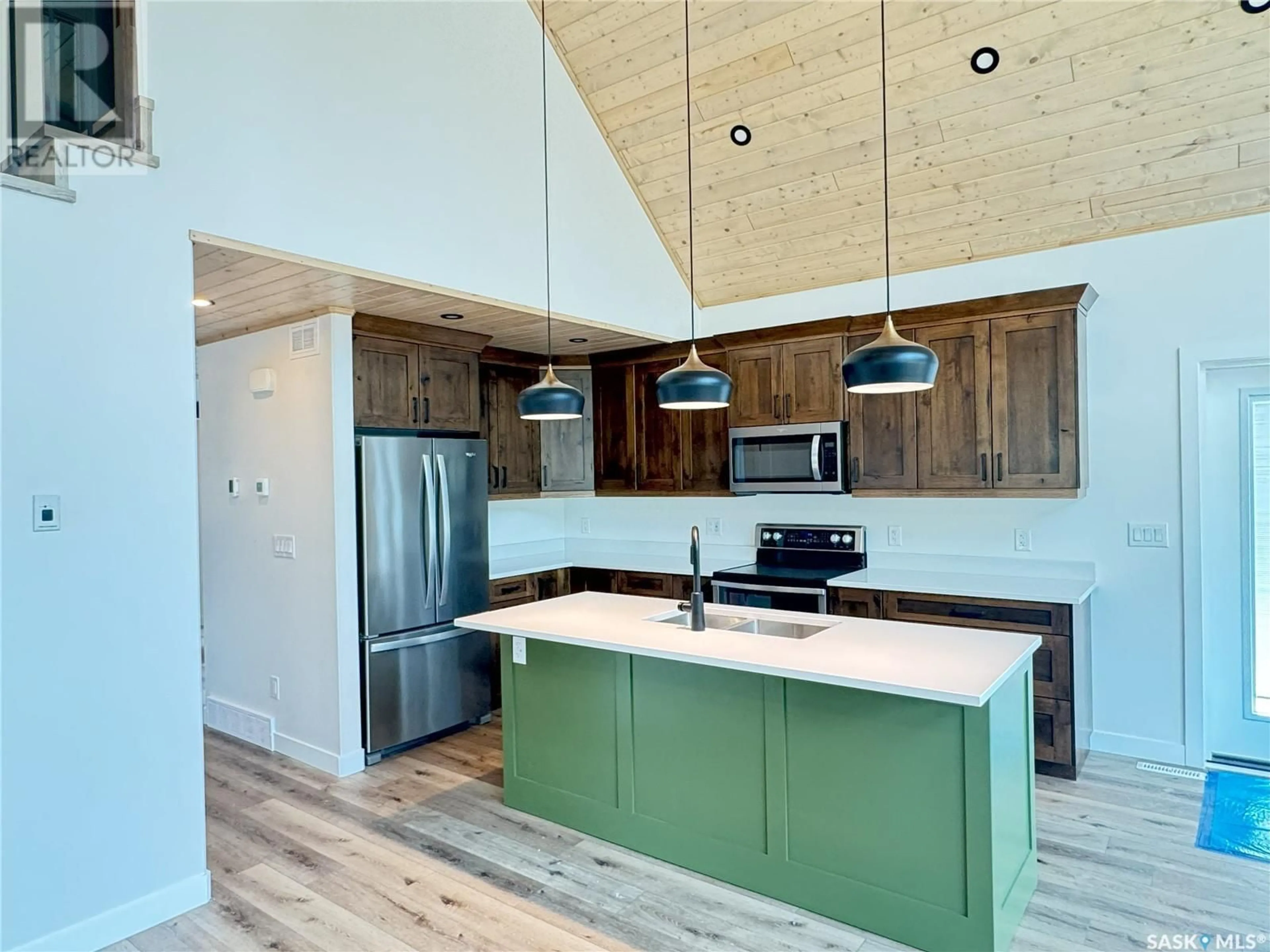 Open concept kitchen, wood/laminate floor for MCPHEE LAKE-WAPITI DEVELOPMENT, Lakeland Rm No. 521 Saskatchewan S0J0N0