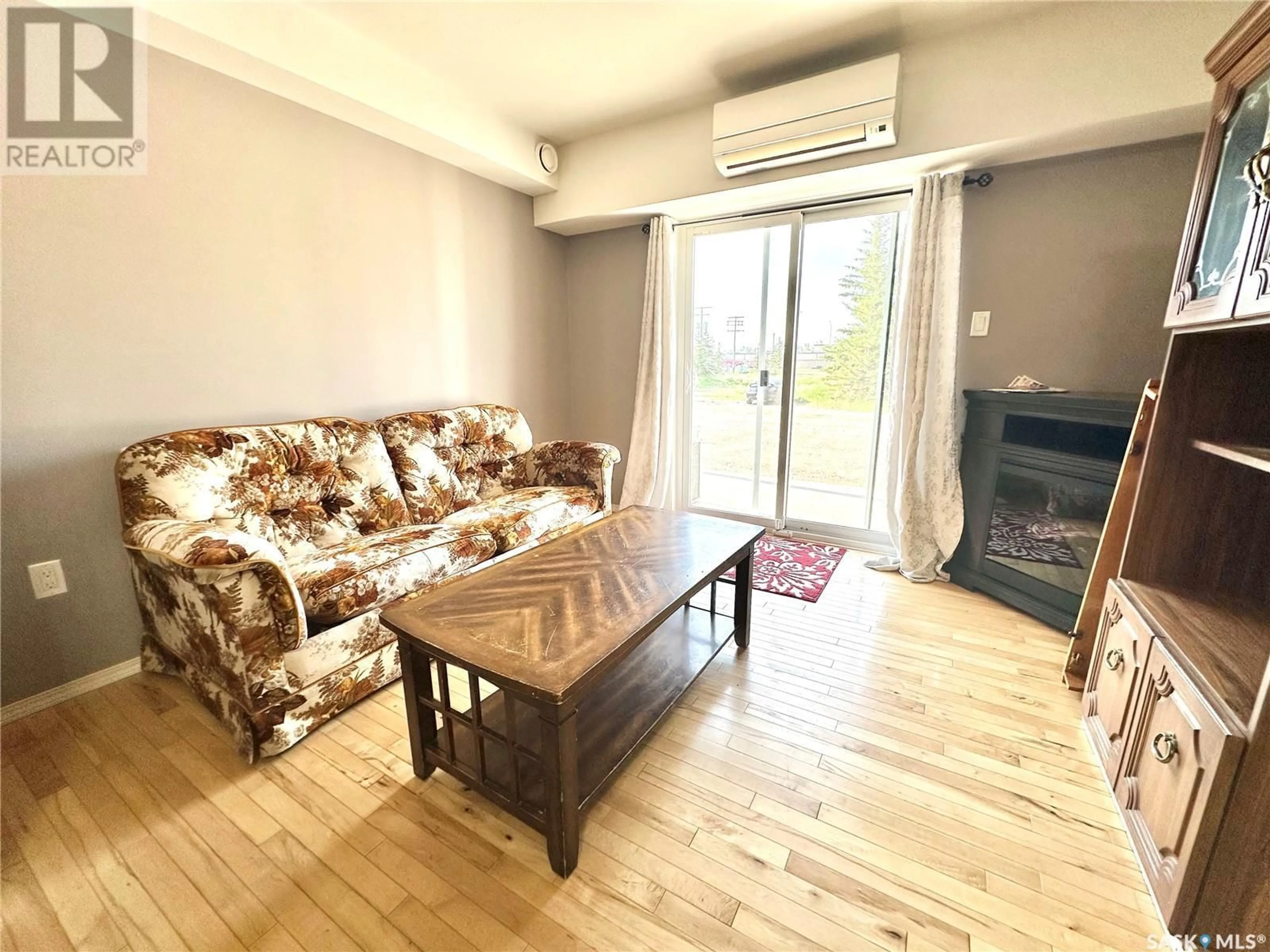 Living room with furniture, wood/laminate floor for 104 - 2322 KILDEER DRIVE, North Battleford Saskatchewan S9A3T5