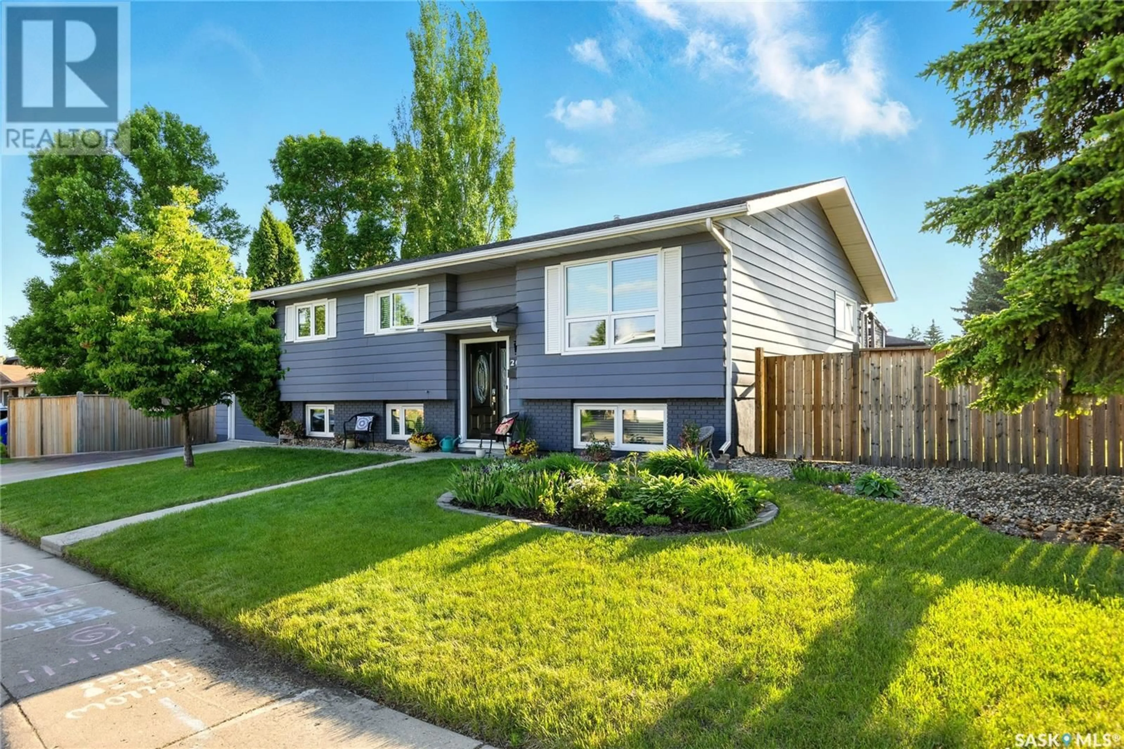 Home with vinyl exterior material, street for 207 DORE CRESCENT, Saskatoon Saskatchewan S7K4X8