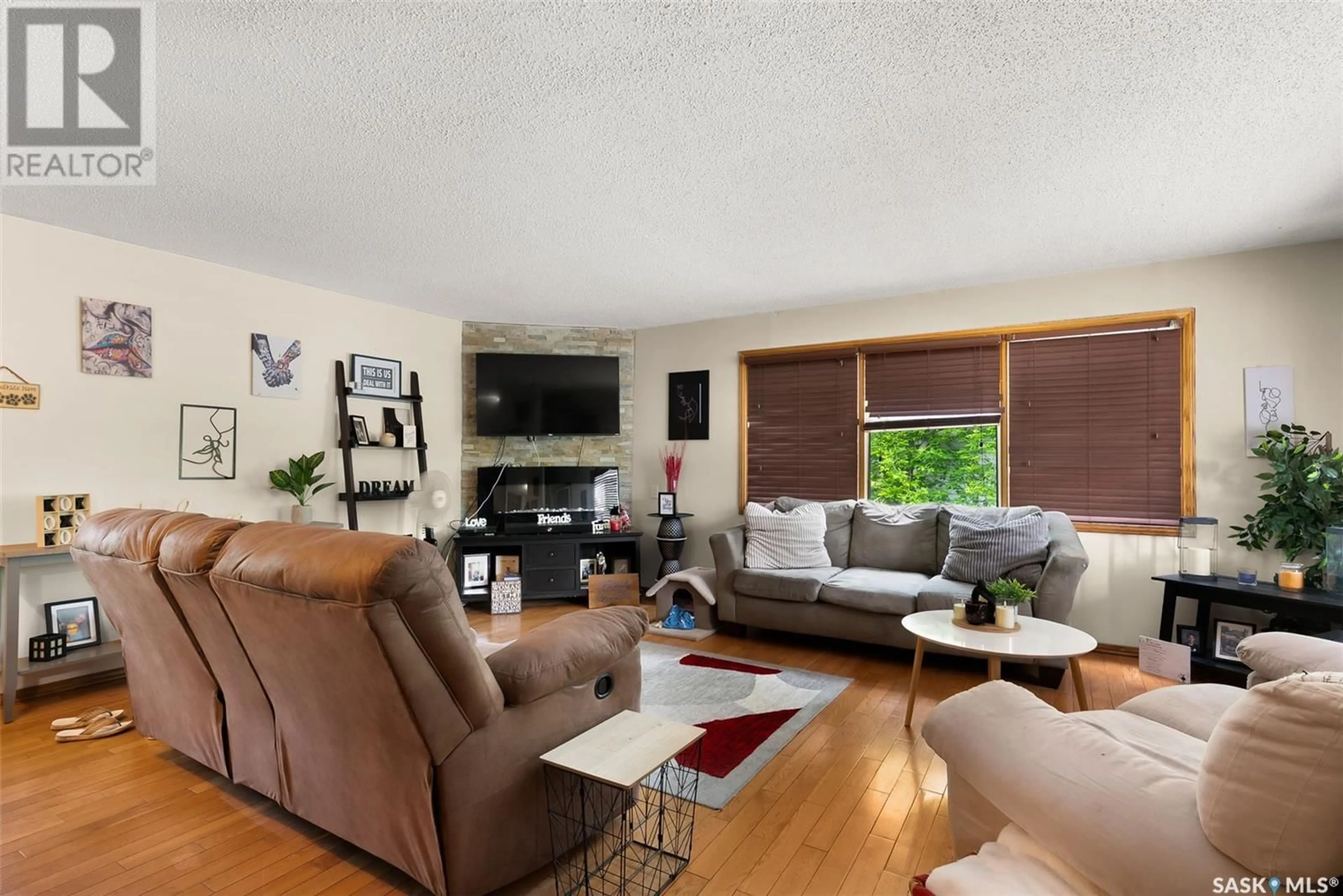 Living room with furniture, wood/laminate floor for 232 1ST STREET, Regina Beach Saskatchewan S0G4C0
