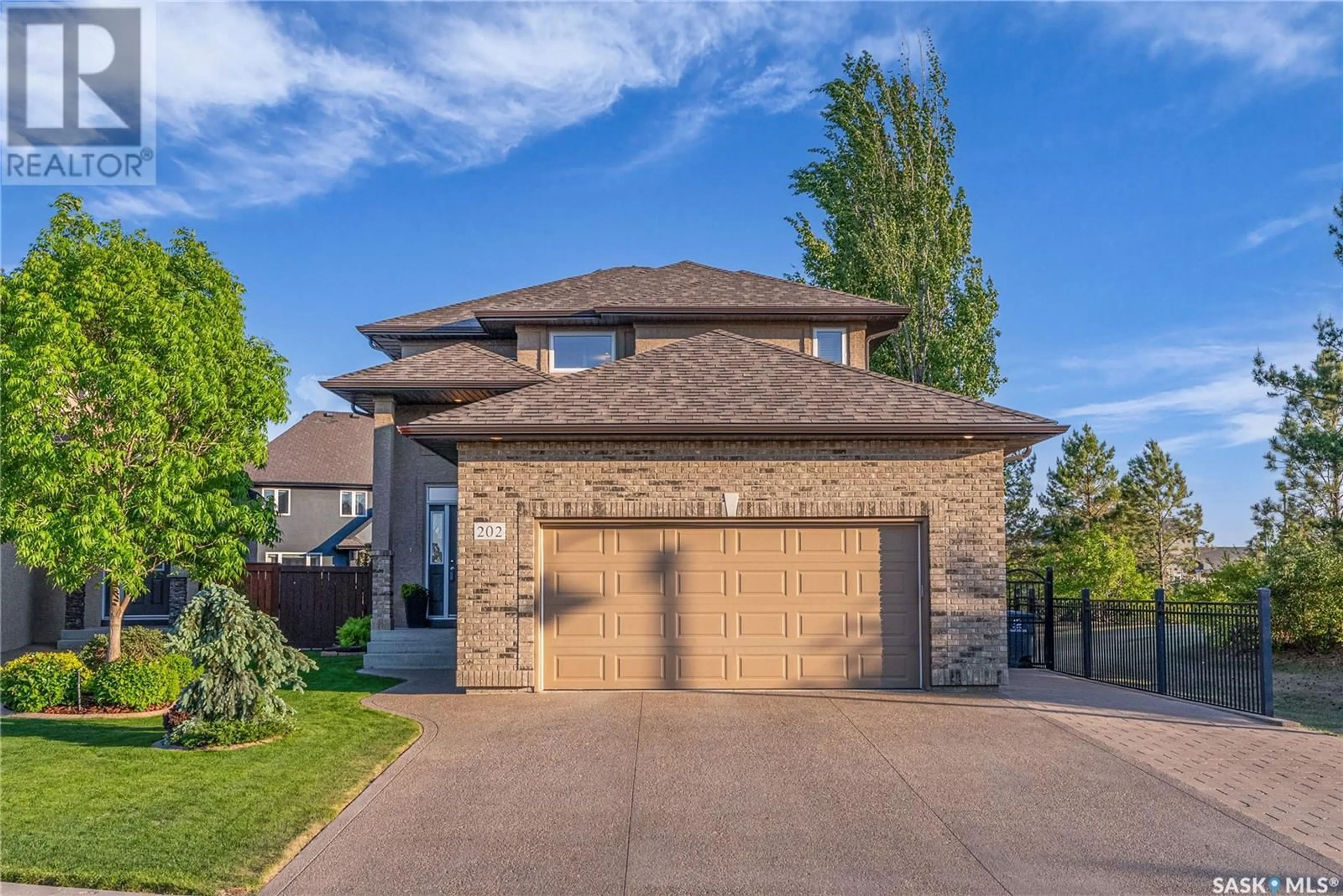 Home with brick exterior material, street for 202 ROBERTSON COVE, Saskatoon Saskatchewan S7T0E3