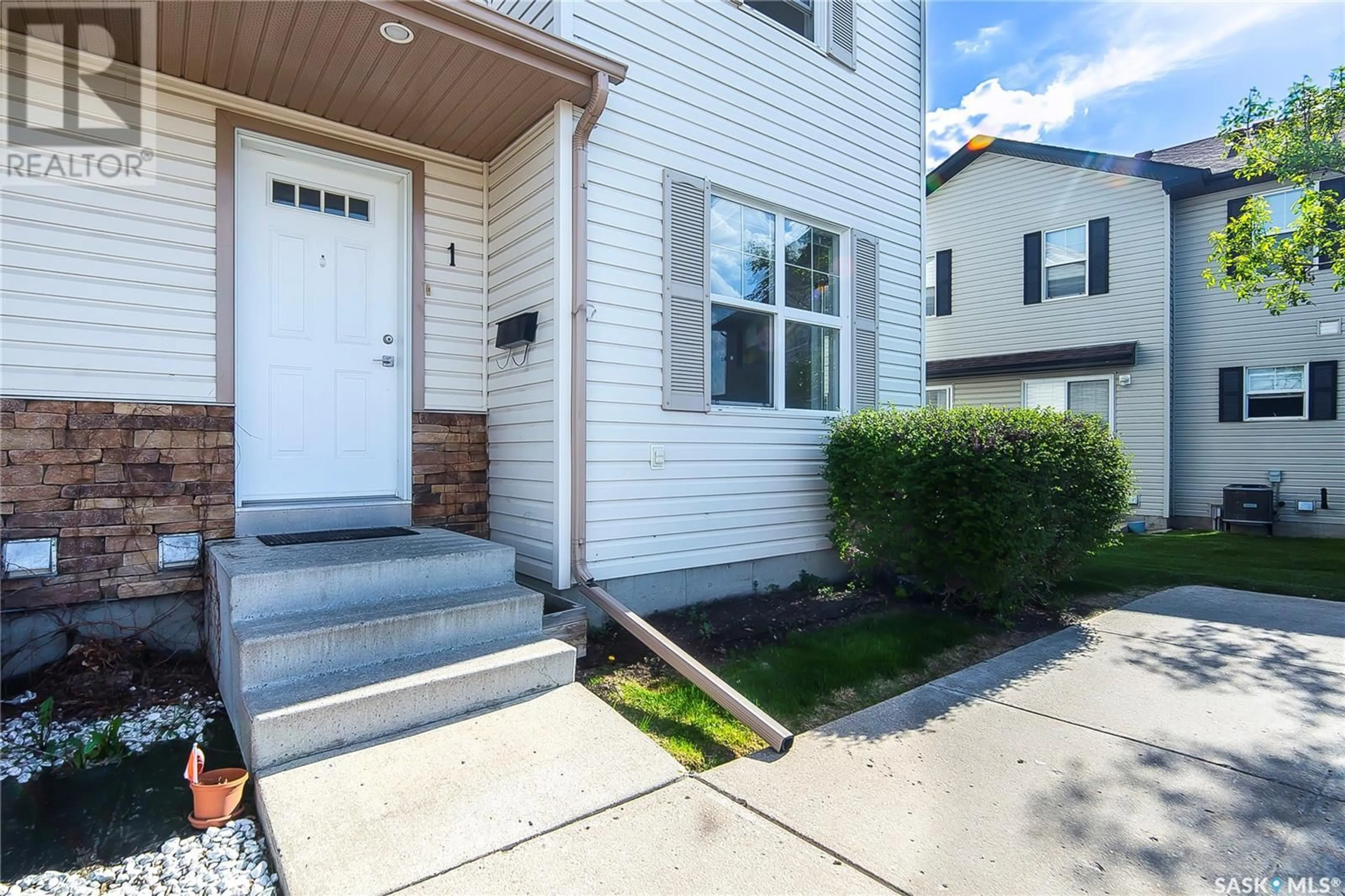 Home with vinyl exterior material, street for 1 - 135 PAWLYCHENKO LANE, Saskatoon Saskatchewan S7V1J8