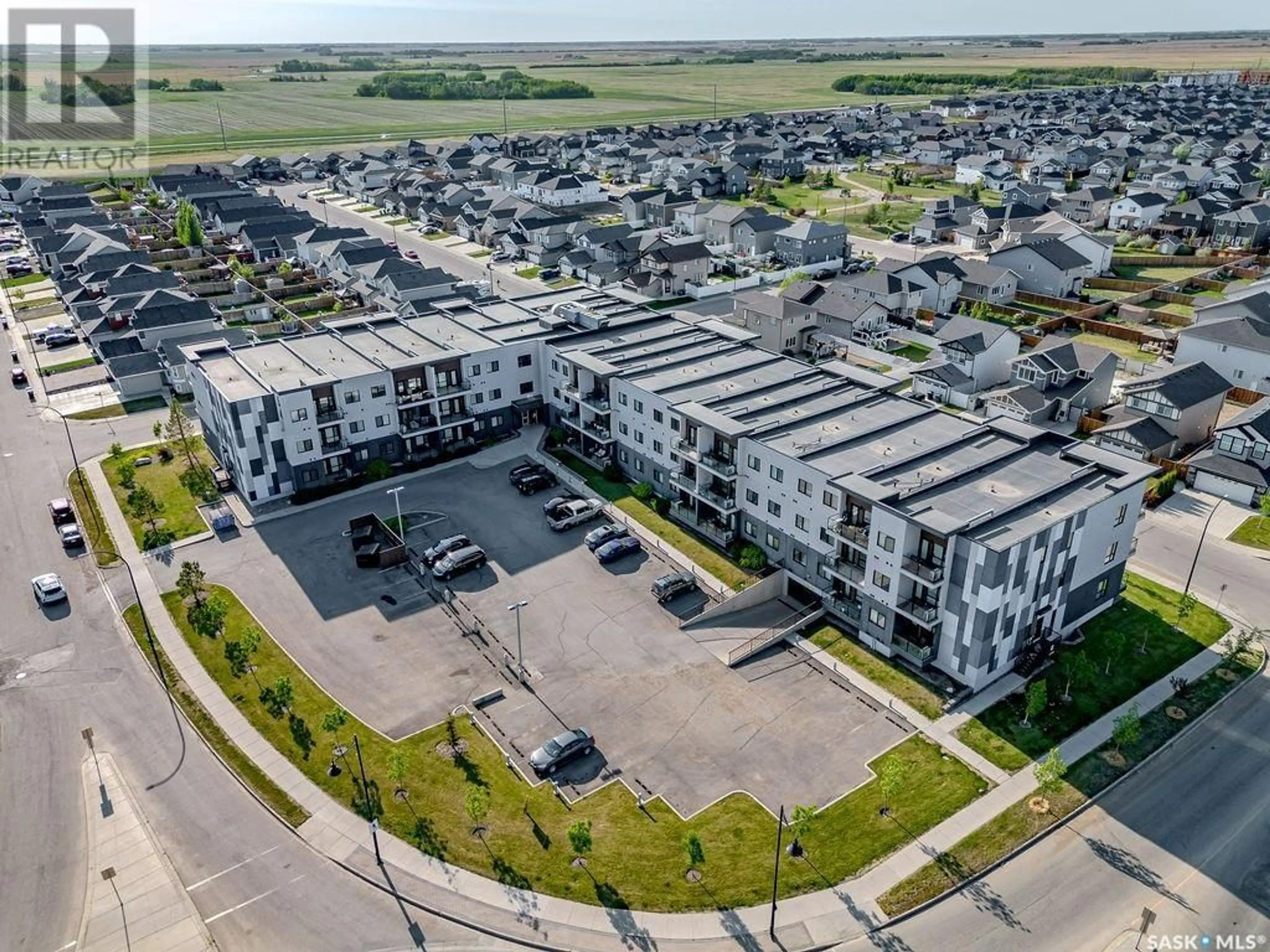 A pic from outside/outdoor area/front of a property/back of a property/a pic from drone, street for 545 - 214 HASSARD CLOSE, Saskatoon Saskatchewan S7L6V3