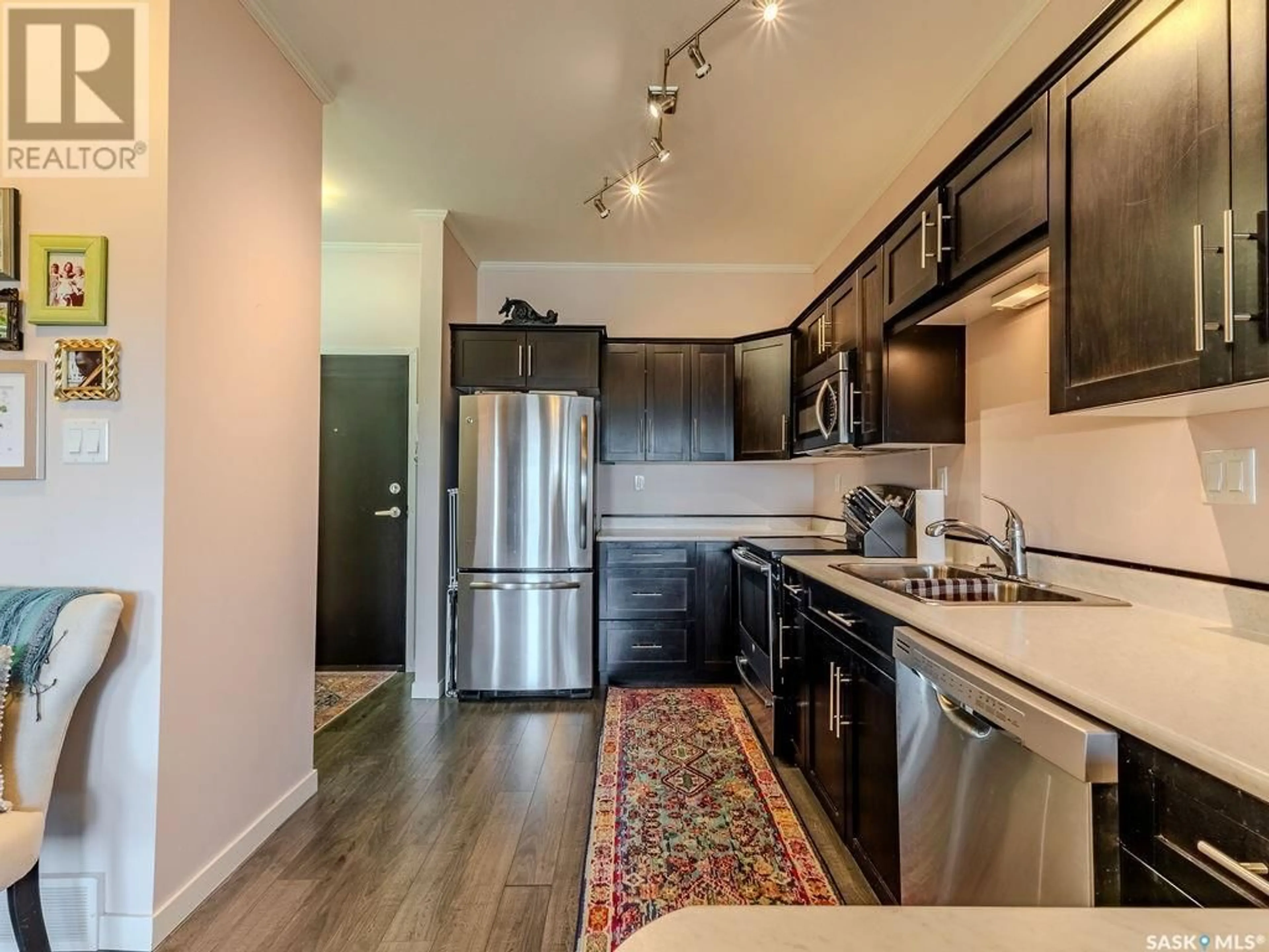 Open concept kitchen, wood/laminate floor for 545 - 214 HASSARD CLOSE, Saskatoon Saskatchewan S7L6V3