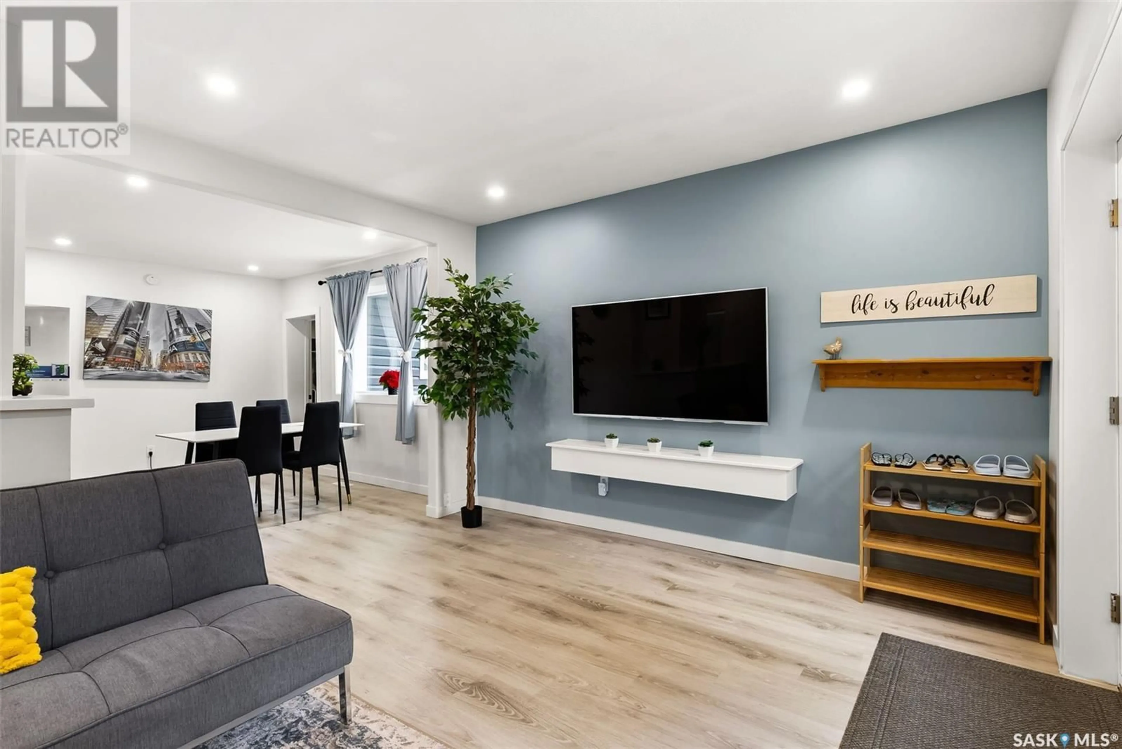 Living room with furniture, wood/laminate floor for 2076 QUEEN STREET, Regina Saskatchewan S4T4C1