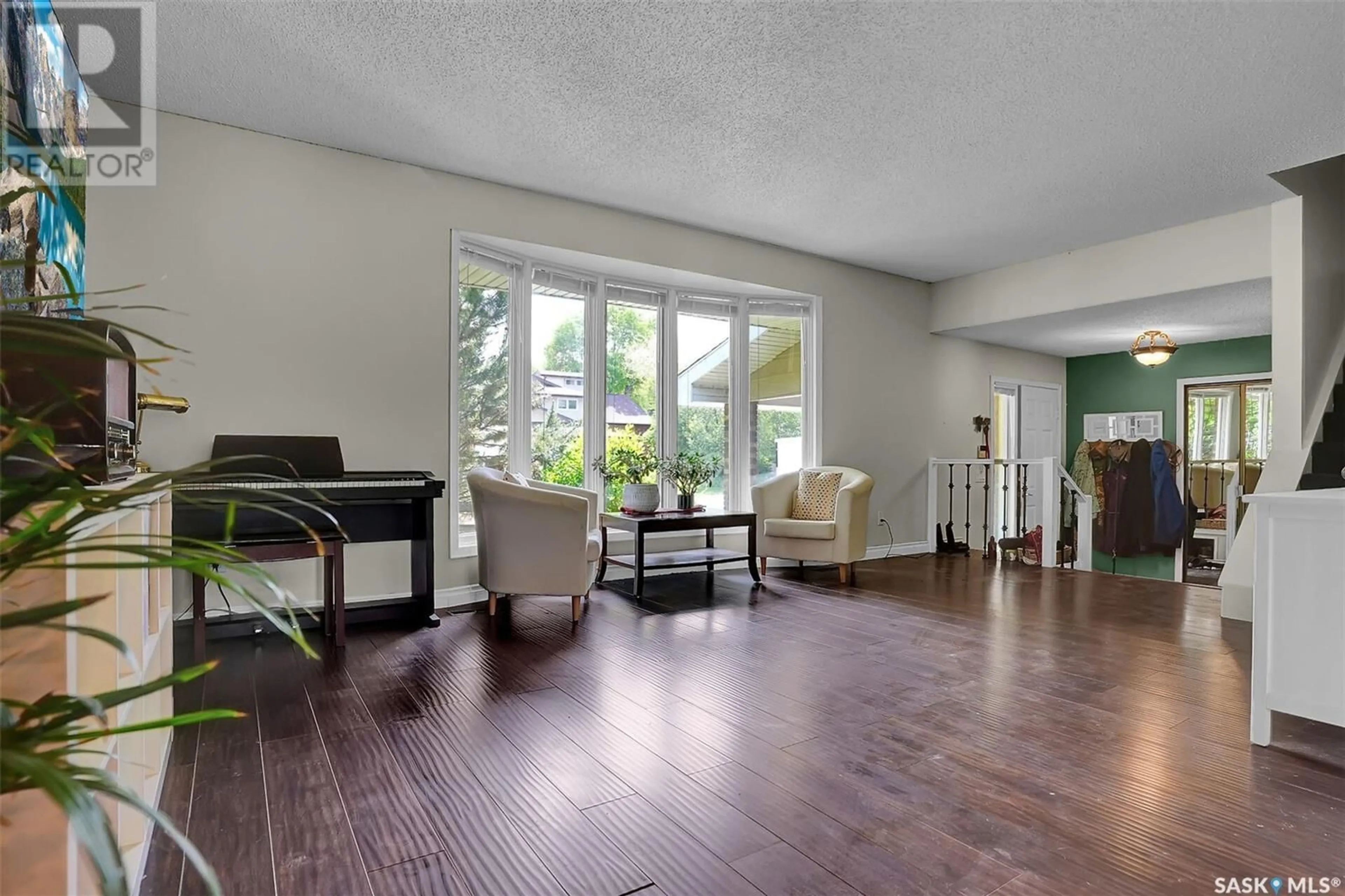 Living room with furniture, wood/laminate floor for 54 METCALFE ROAD, Regina Saskatchewan S4V0H8
