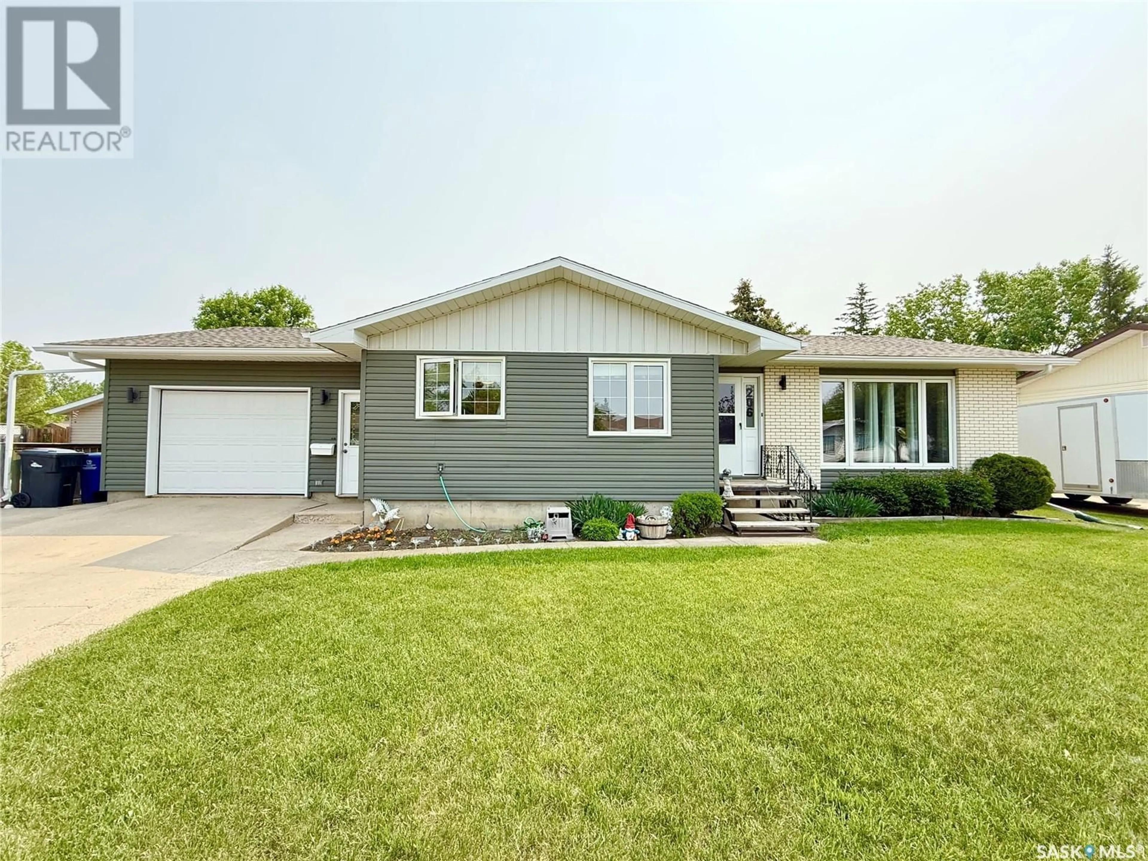 Home with vinyl exterior material, street for 206 ONSTAD CRESCENT, Weyburn Saskatchewan S4H2T2