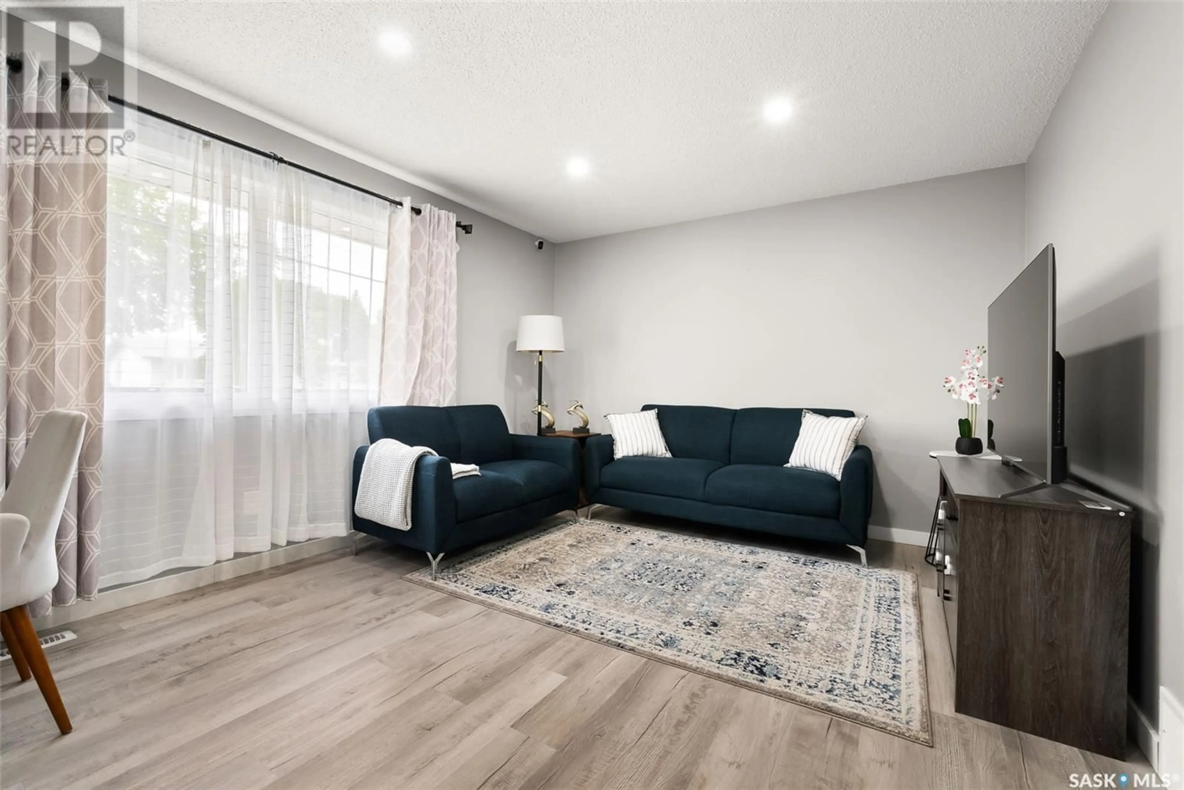 Living room with furniture, wood/laminate floor for 139 QUEBEC STREET, Regina Saskatchewan S4R2S2
