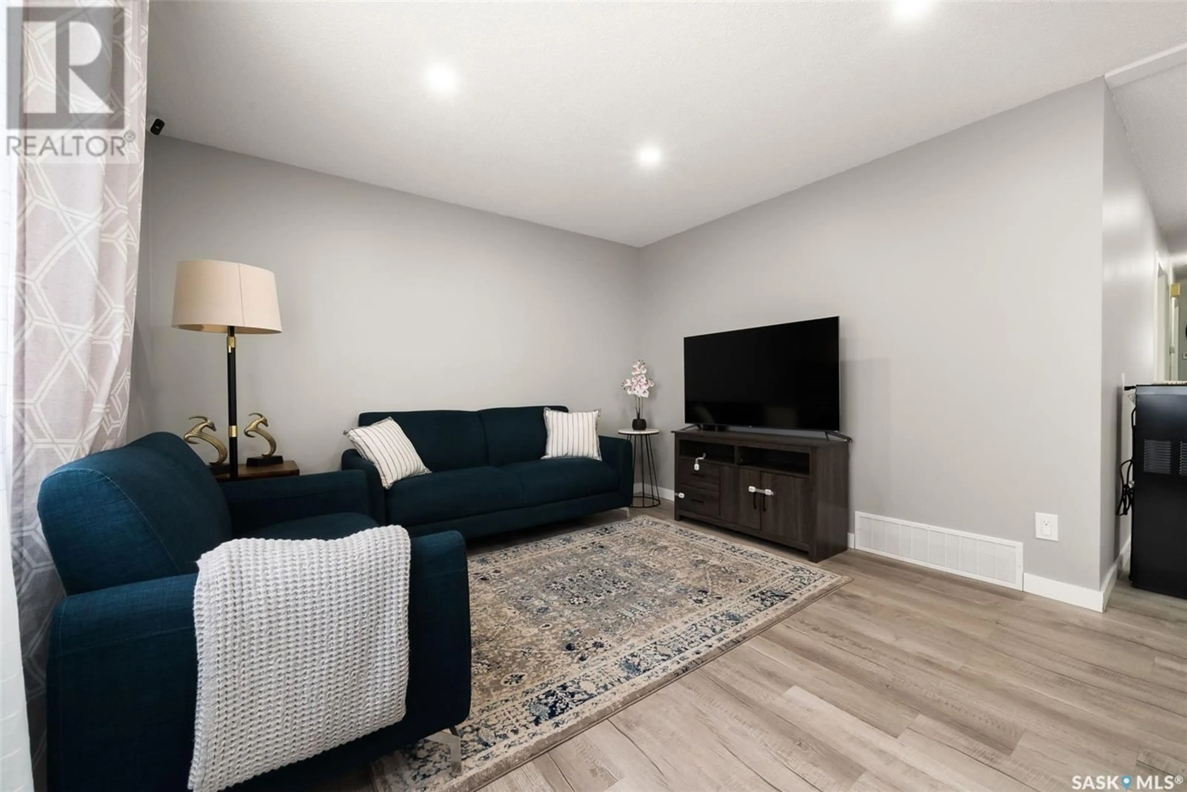 Living room with furniture, wood/laminate floor for 139 QUEBEC STREET, Regina Saskatchewan S4R2S2