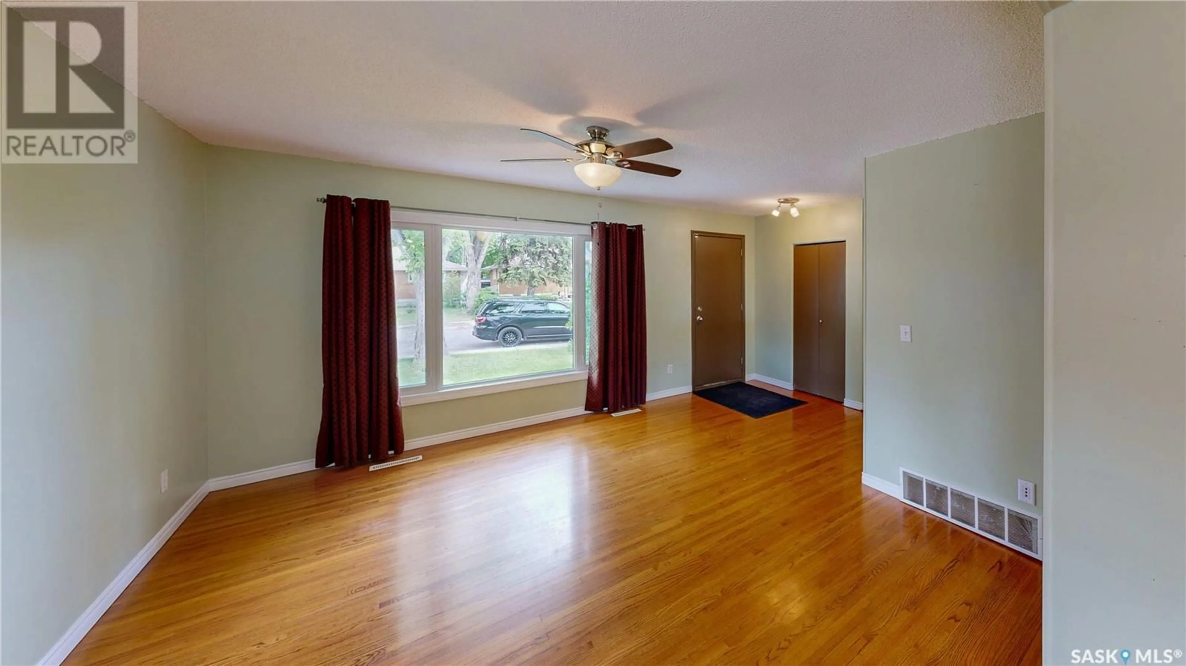Living room with furniture, wood/laminate floor for 3209 PATRICIA AVENUE, Regina Saskatchewan S4R3V8