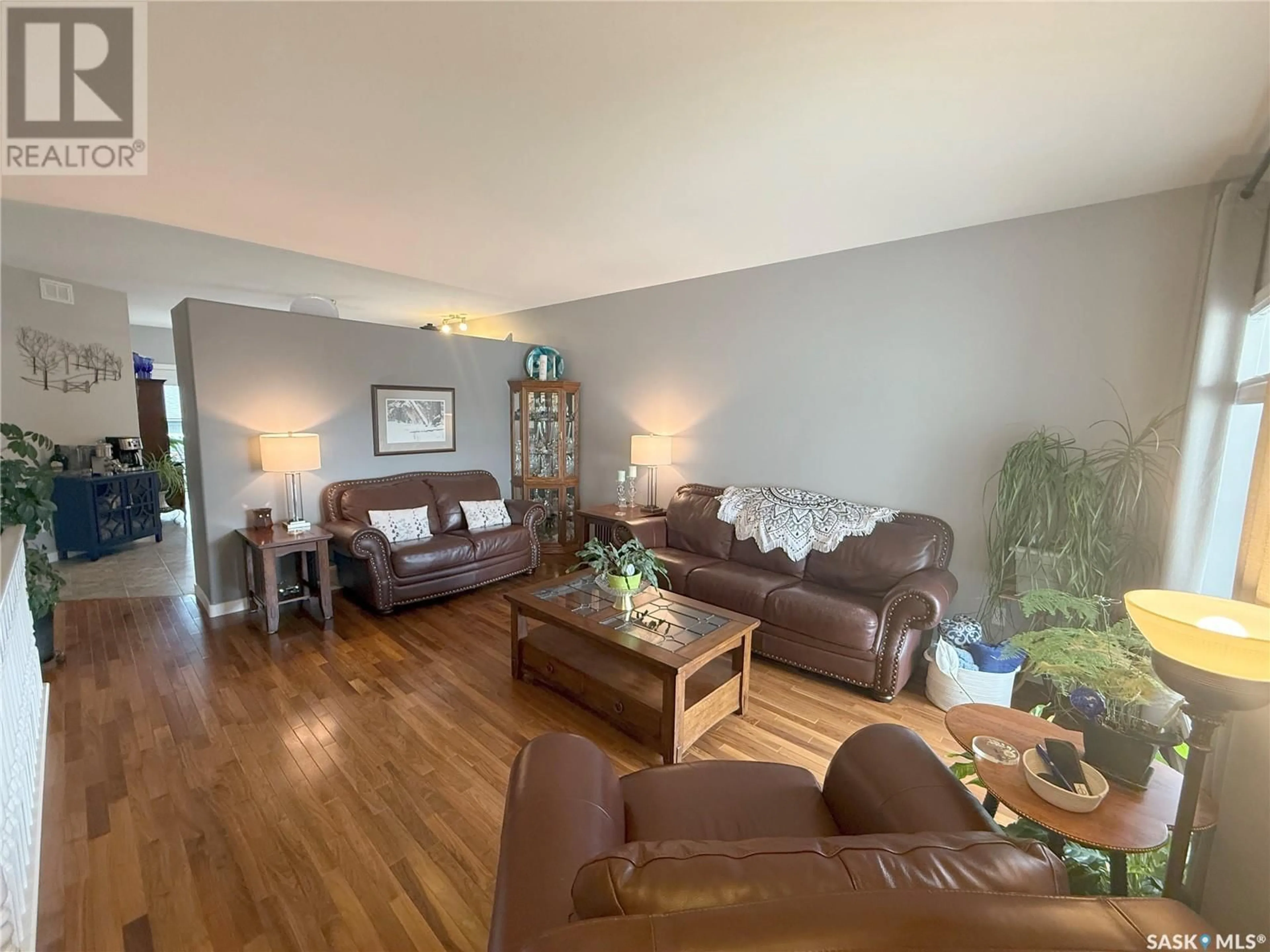 Living room with furniture, wood/laminate floor for 767 SANDSTONE TERRACE, Martensville Saskatchewan S0K2T2