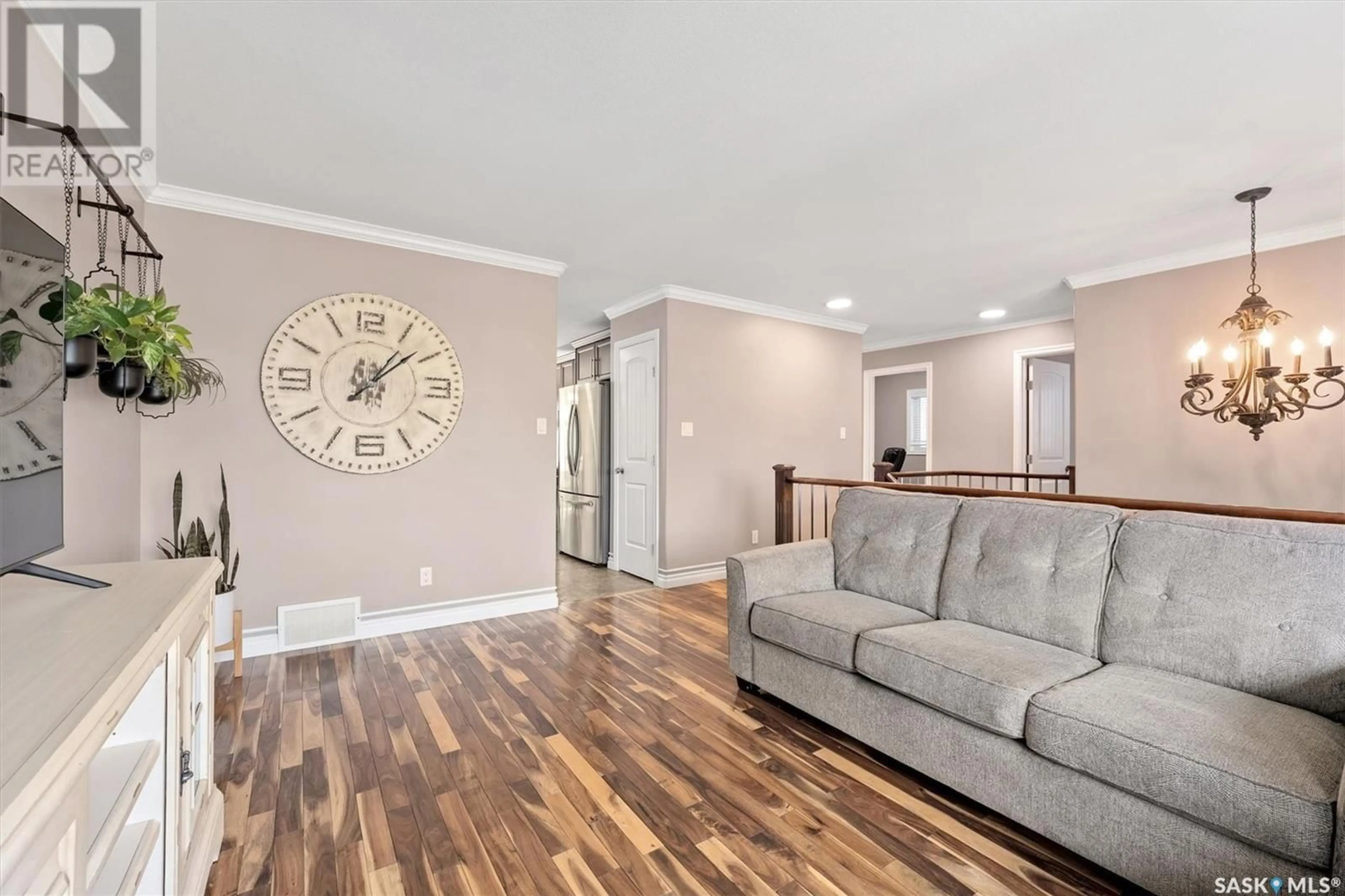 Living room with furniture, wood/laminate floor for 3283 MCCLOCKLIN ROAD, Saskatoon Saskatchewan S7R0B9