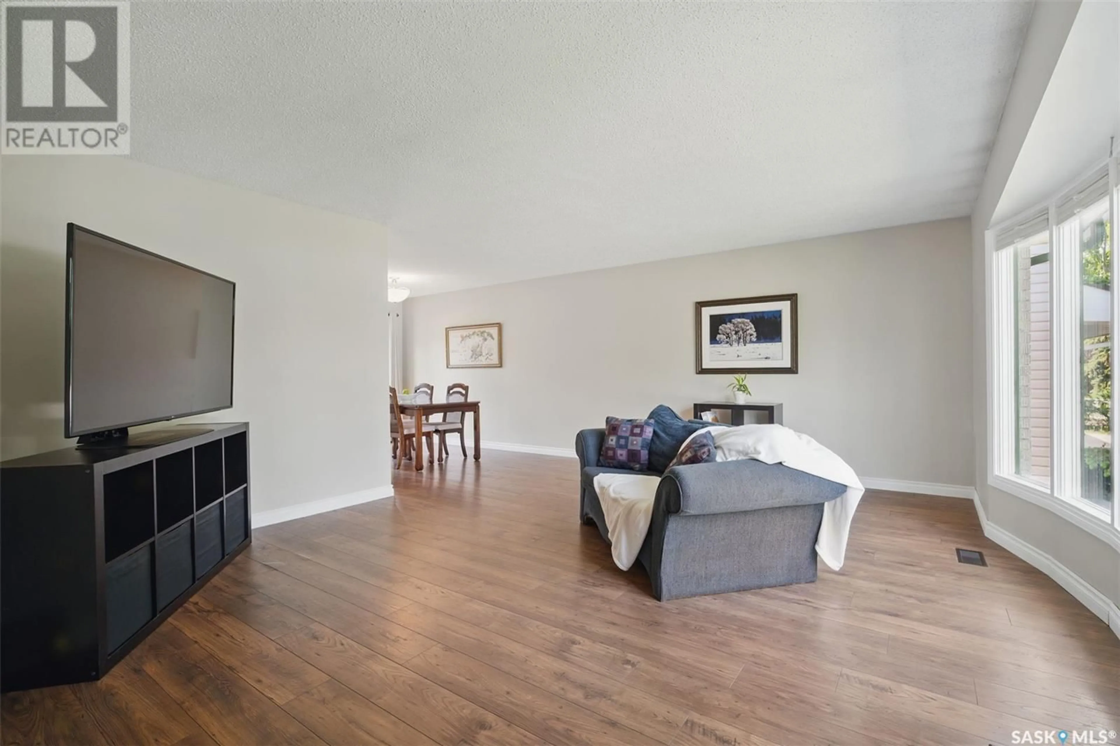 Living room with furniture, wood/laminate floor for 74 DEGEER CRESCENT, Saskatoon Saskatchewan S7H4P7