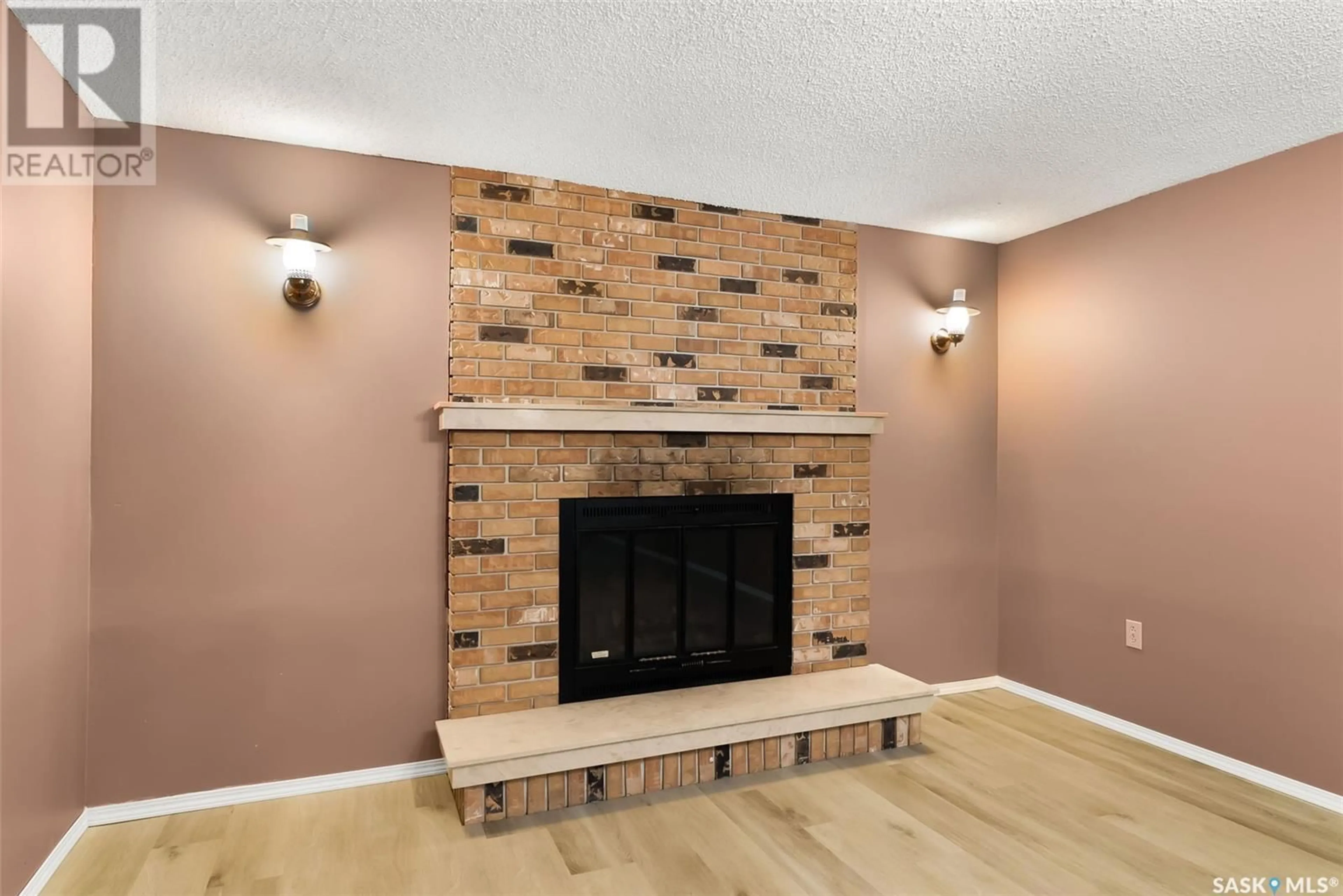 Living room with furniture, wood/laminate floor for 105 1ST AVENUE, Kelliher Saskatchewan S0A1V0