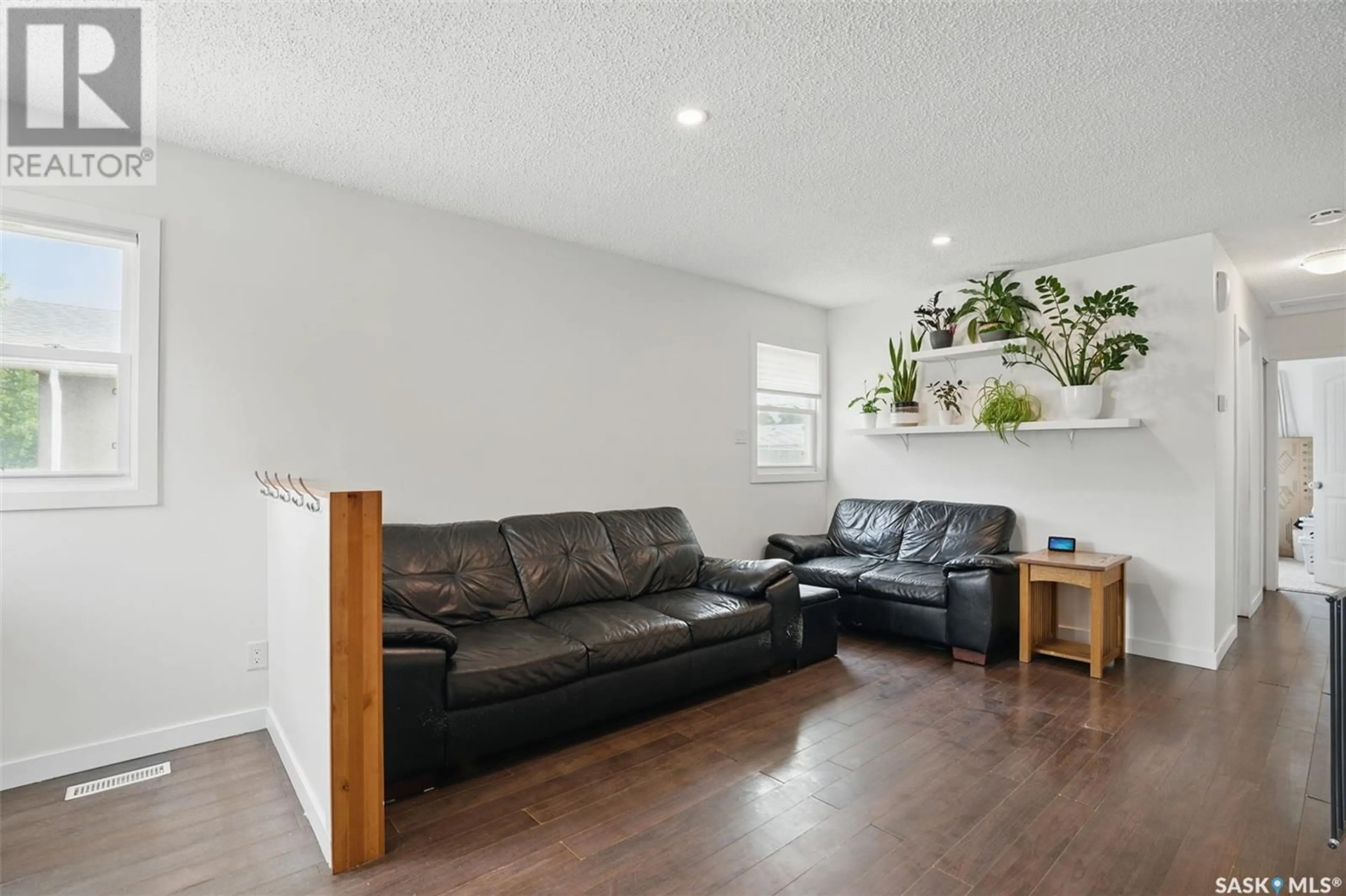 Living room with furniture, wood/laminate floor for 429 LANGEVIN CRESCENT, Saskatoon Saskatchewan S7L5R5