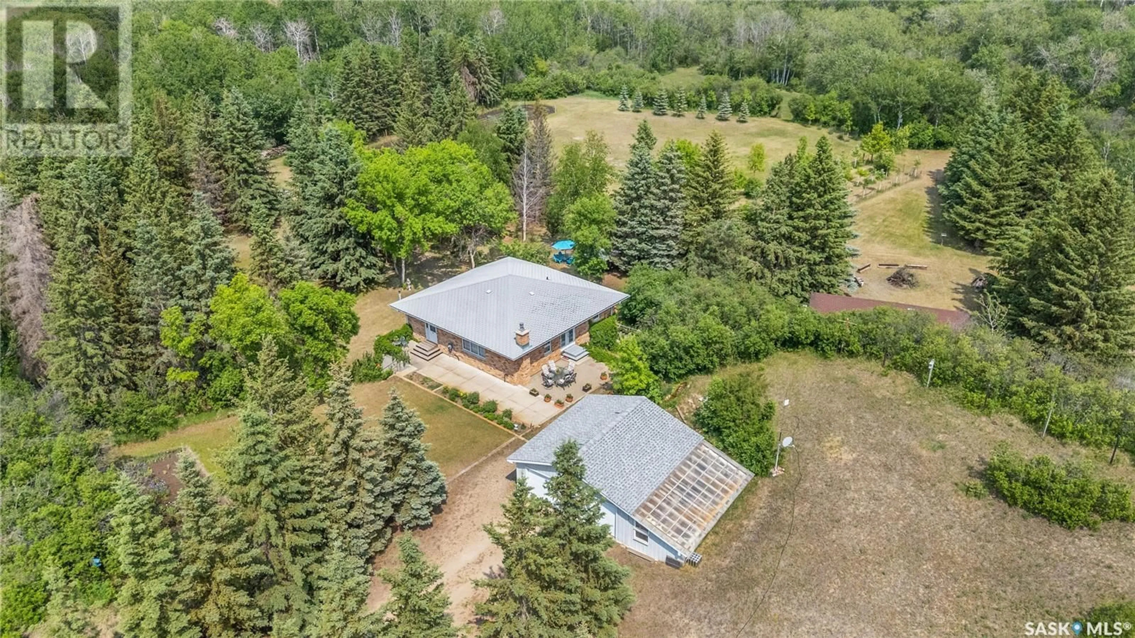 A pic from outside/outdoor area/front of a property/back of a property/a pic from drone, forest/trees view for STUGLIN ACREAGE, Vanscoy Rm No. 345 Saskatchewan S7K1N2