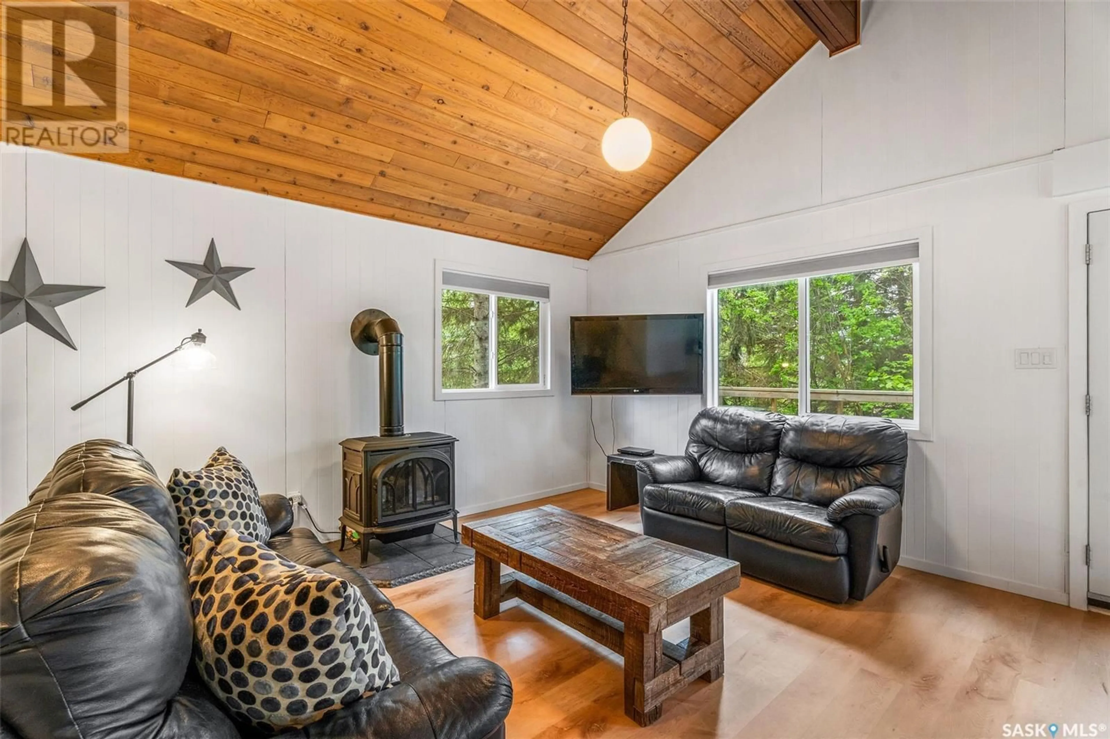 Living room with furniture, wood/laminate floor for 209 LOON DRIVE, Big Shell Saskatchewan S0J2G0