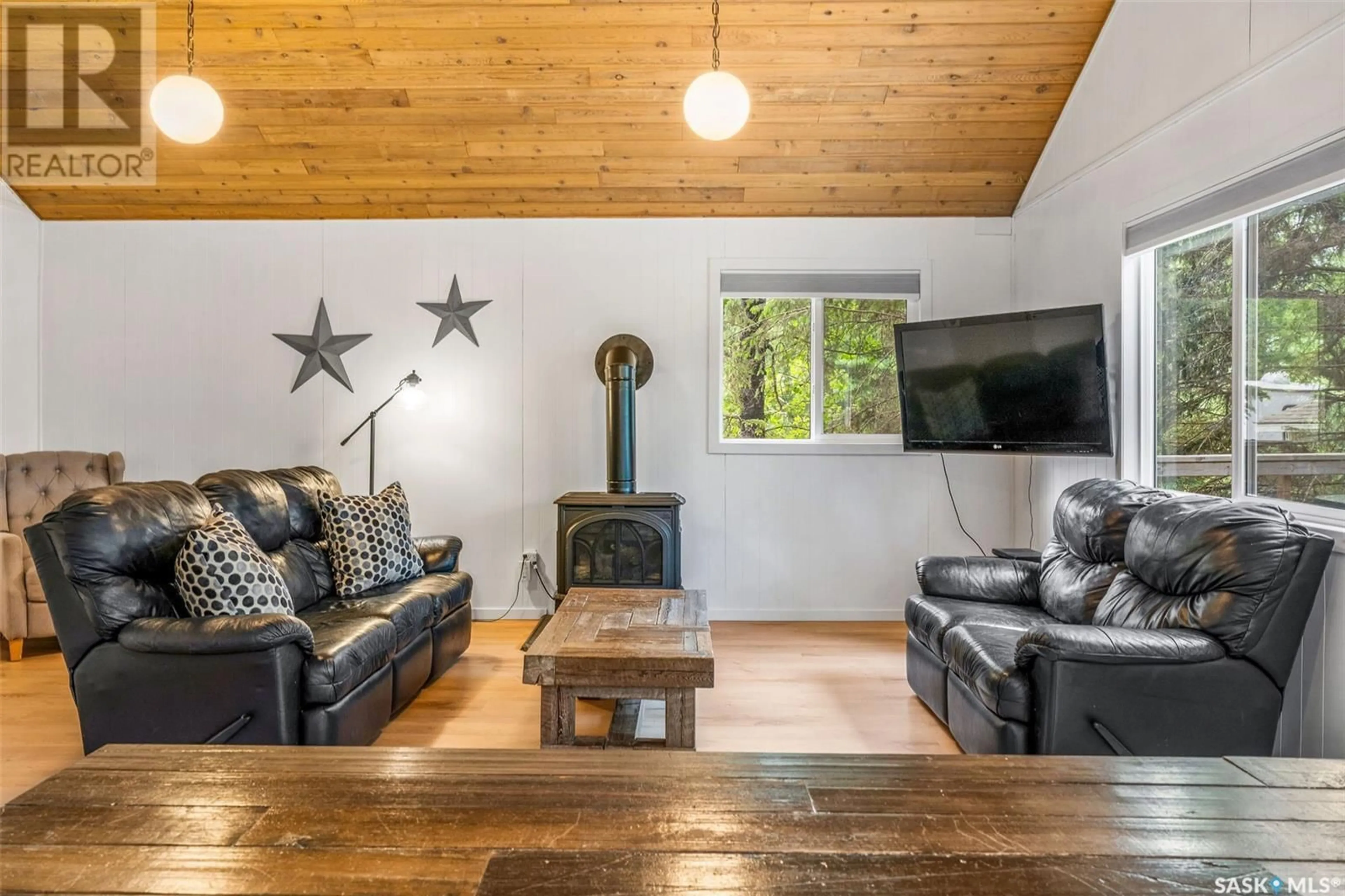 Living room with furniture, wood/laminate floor for 209 LOON DRIVE, Big Shell Saskatchewan S0J2G0