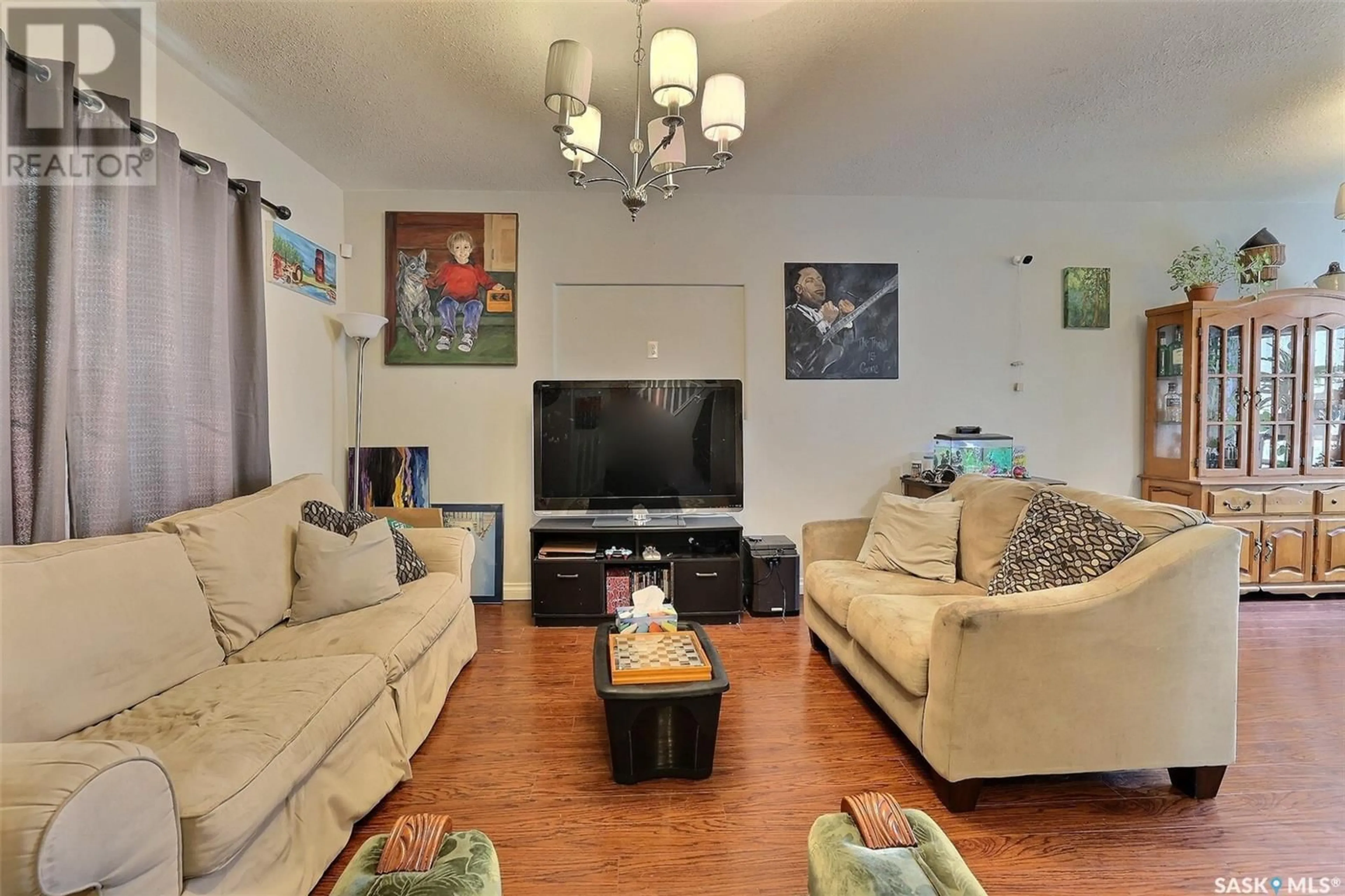 Living room with furniture, wood/laminate floor for 1550 ROBINSON STREET, Regina Saskatchewan S4T2N8