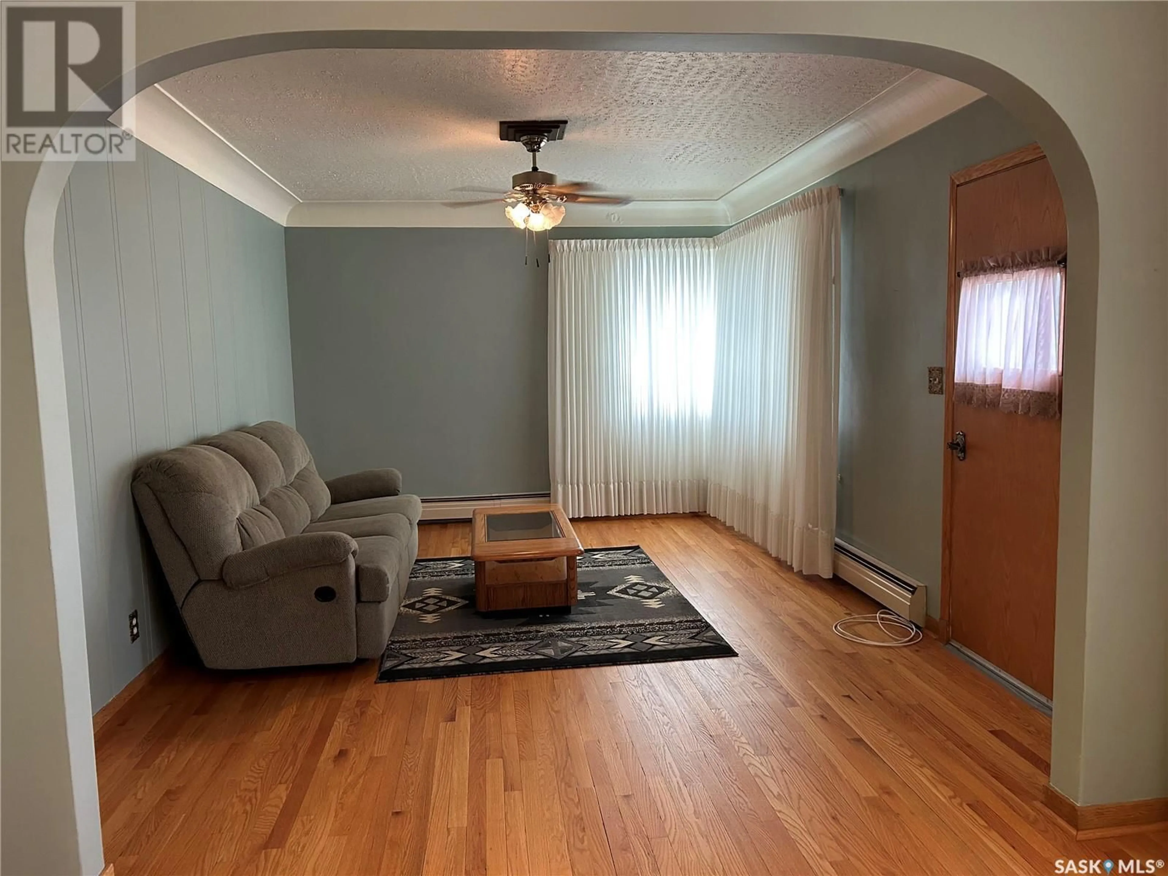 Living room with furniture, wood/laminate floor for 1709 2ND STREET, Estevan Saskatchewan S4A0N2