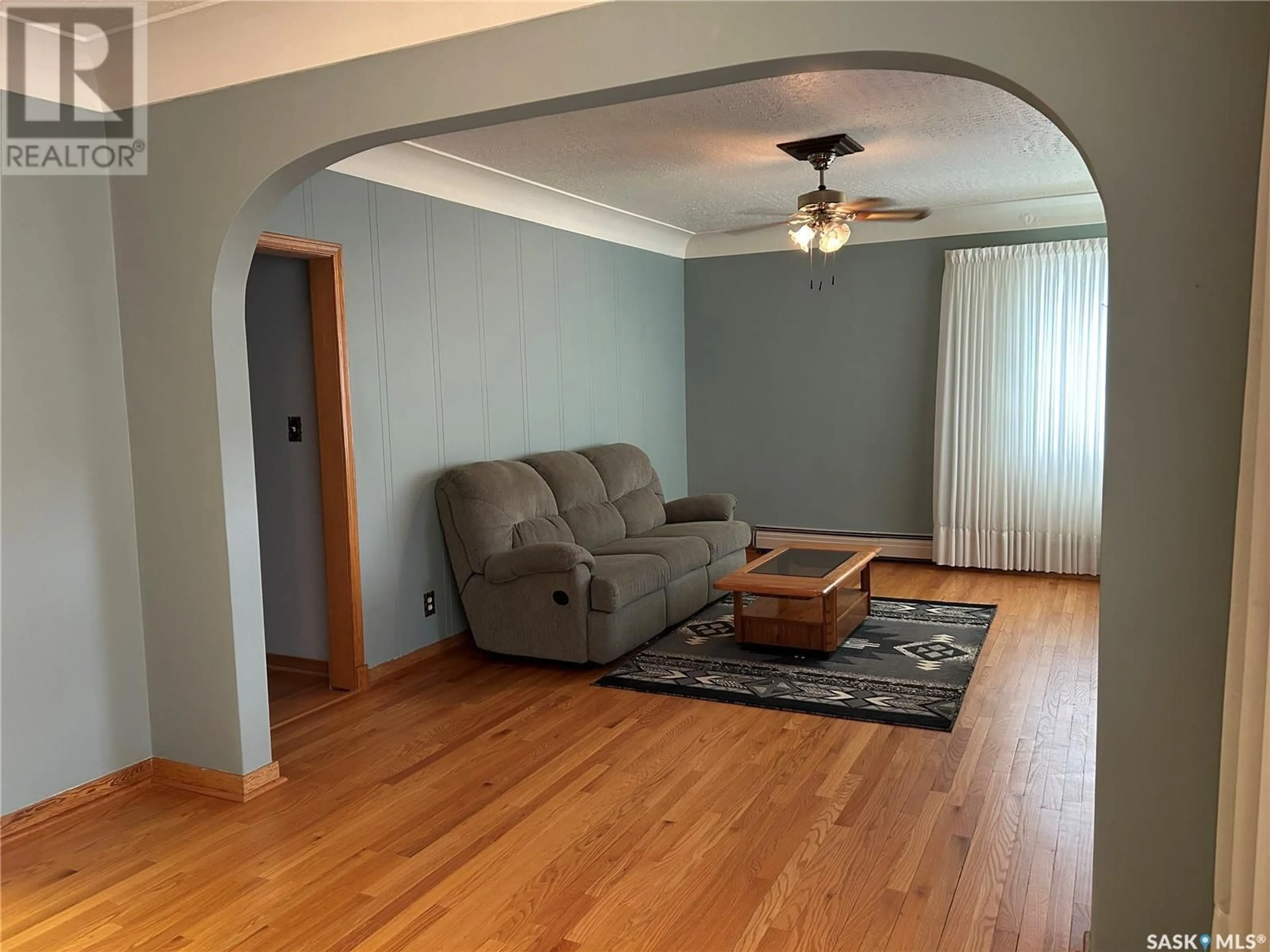 Living room with furniture, wood/laminate floor for 1709 2ND STREET, Estevan Saskatchewan S4A0N2