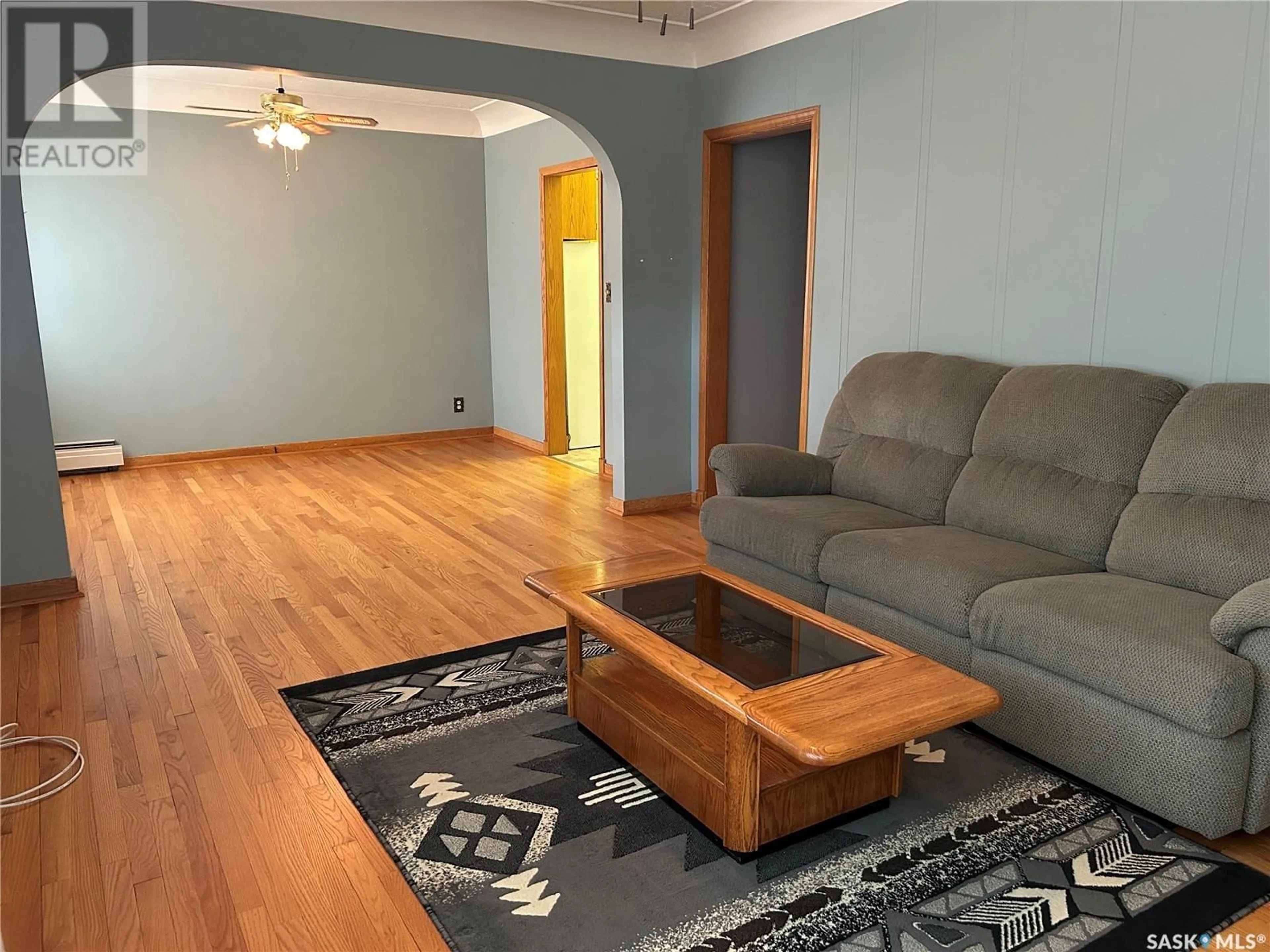 Living room with furniture, wood/laminate floor for 1709 2ND STREET, Estevan Saskatchewan S4A0N2