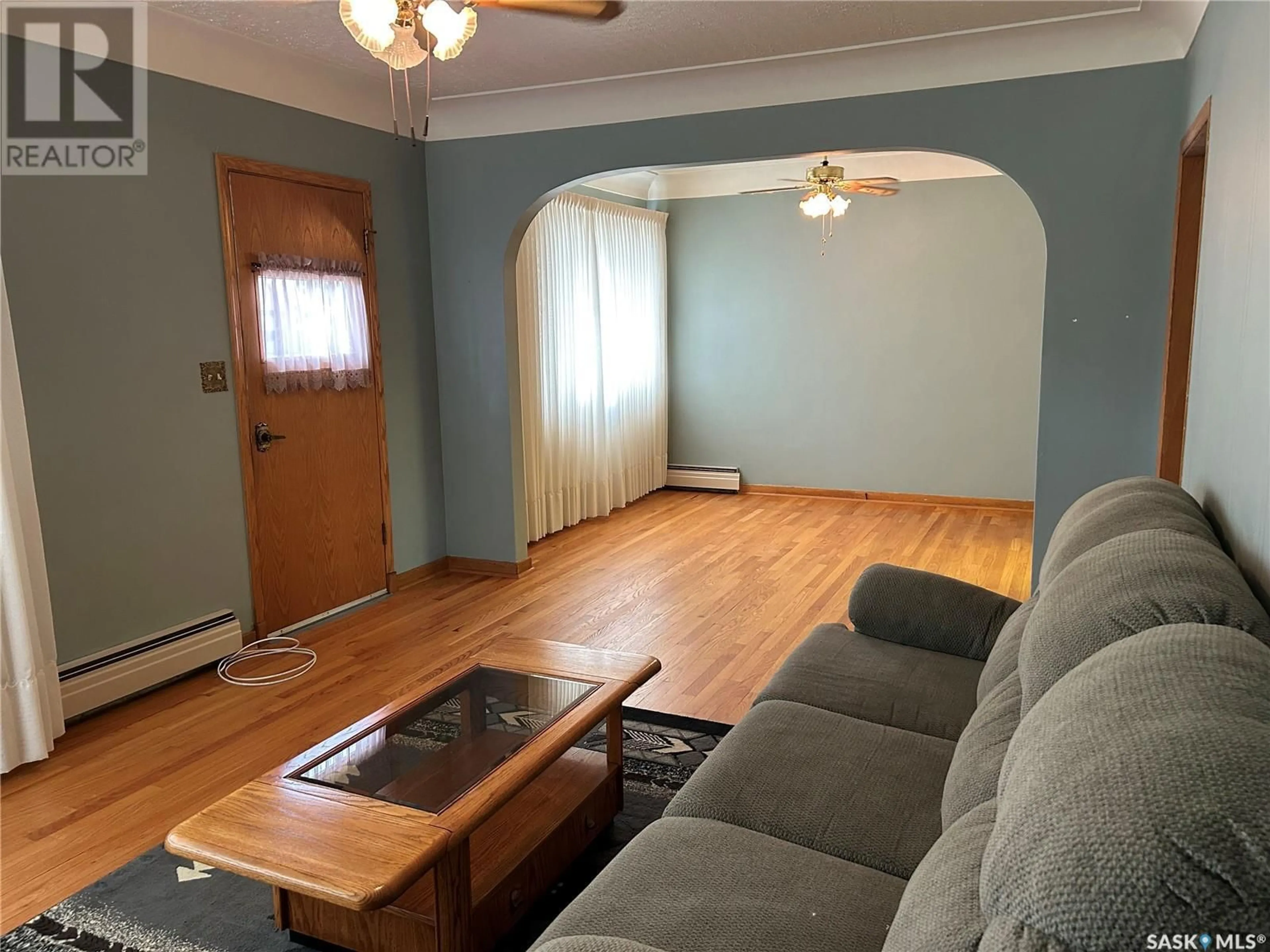 Living room with furniture, wood/laminate floor for 1709 2ND STREET, Estevan Saskatchewan S4A0N2