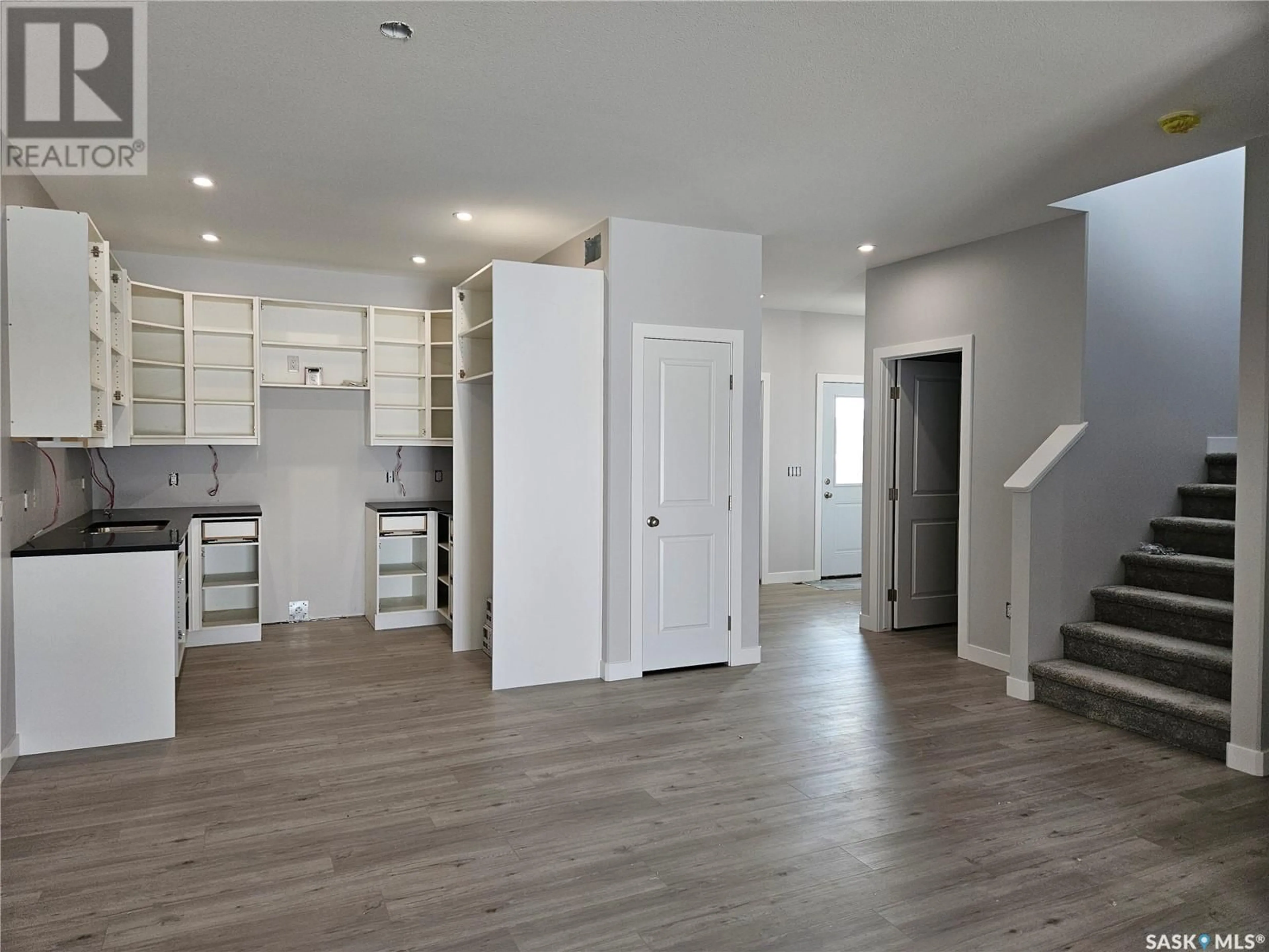 Open concept kitchen, wood/laminate floor for 846 DELAET BAY, Warman Saskatchewan S0K0A1