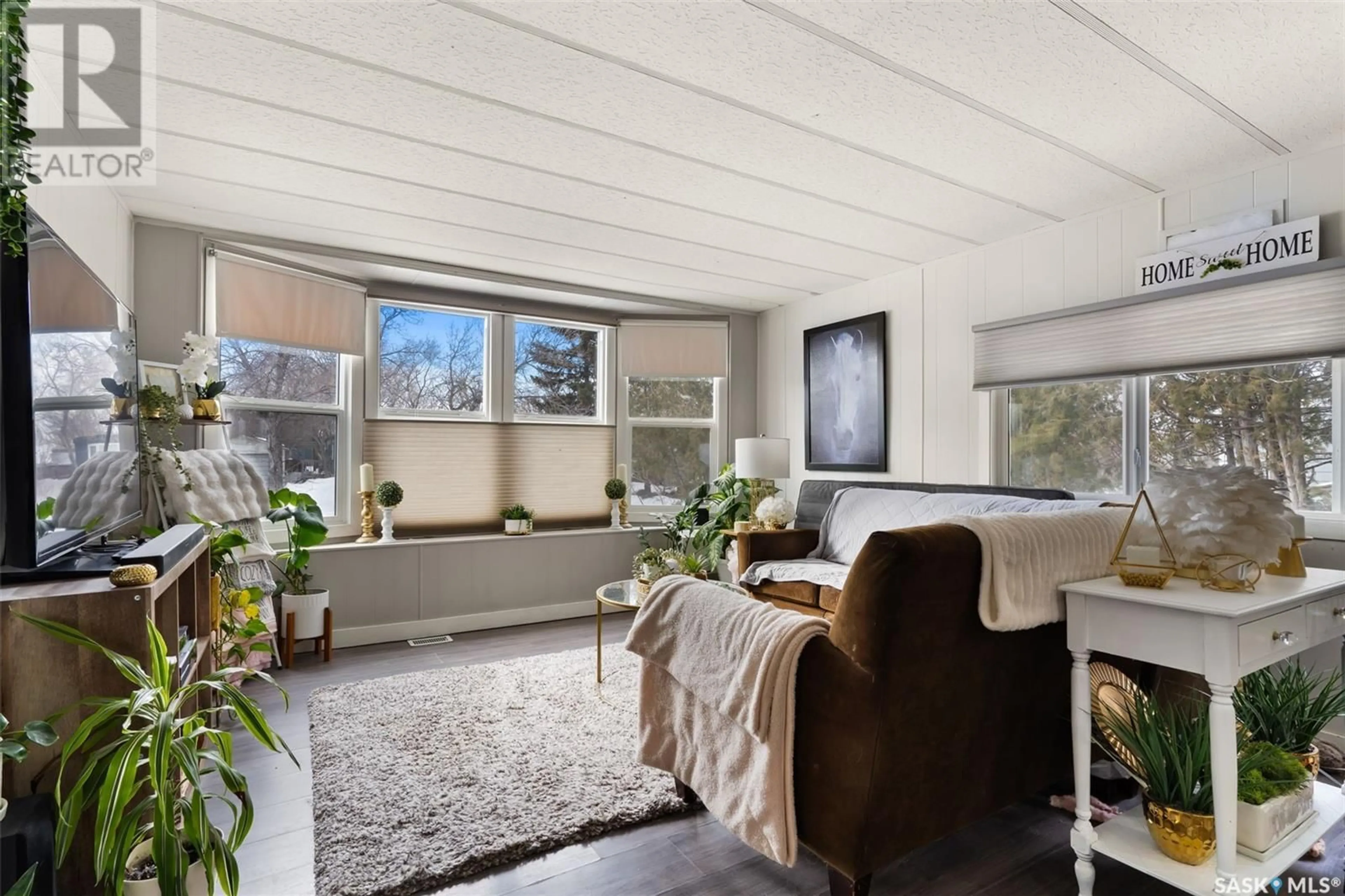 Living room with furniture, wood/laminate floor for 26 GARUIK CRESCENT, Regina Saskatchewan S4S7E6