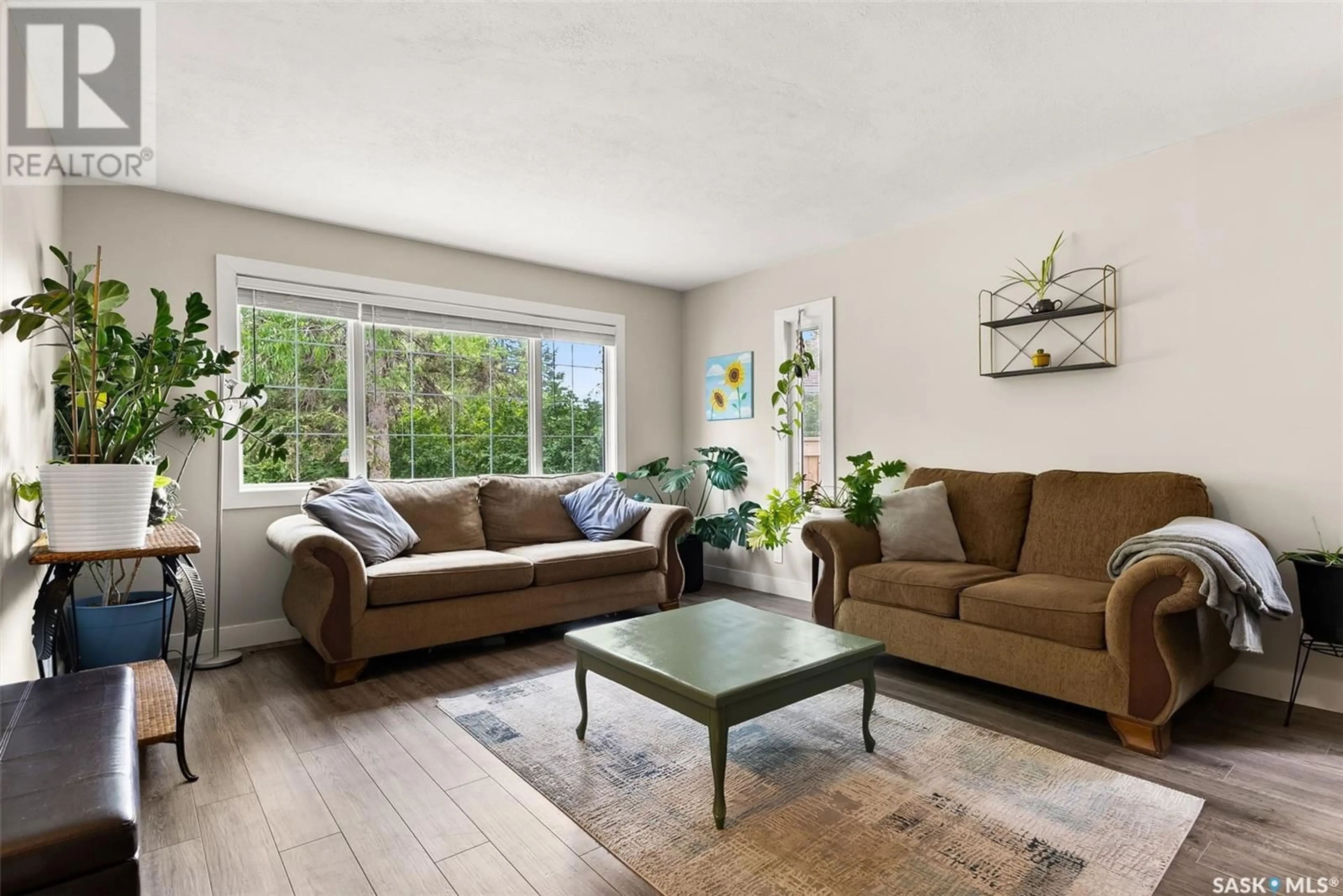 Living room with furniture, wood/laminate floor for 38 FOX GLOVE CRESCENT, Regina Saskatchewan S4S4K7
