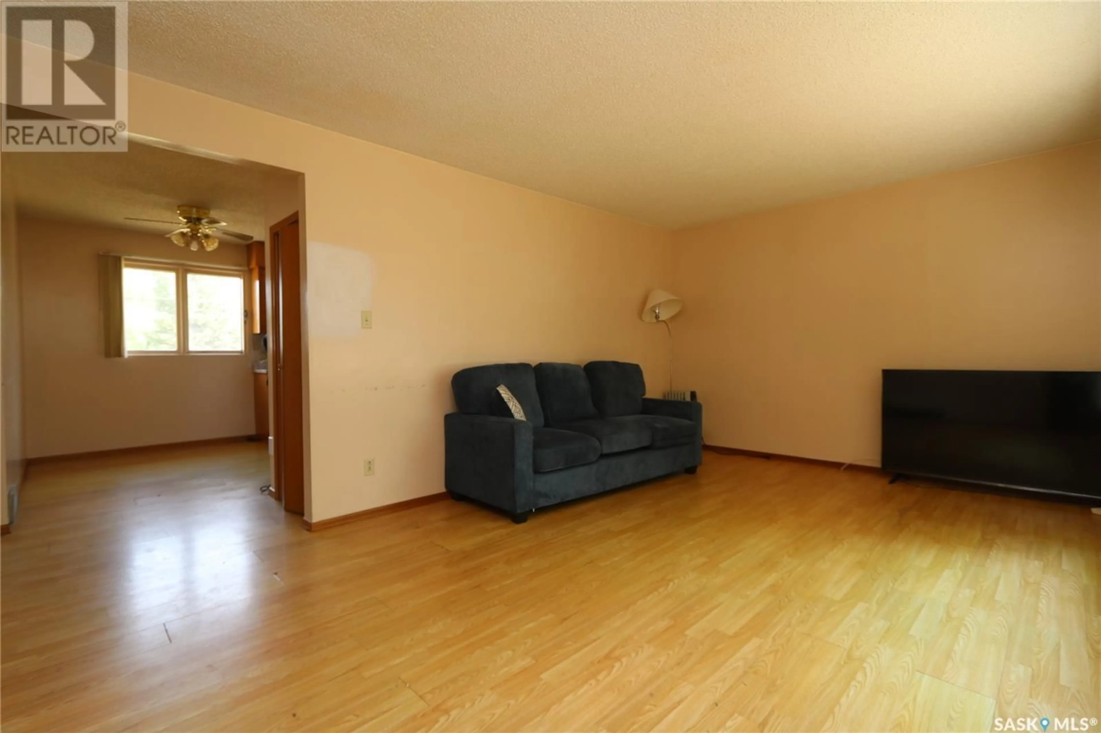 Living room with furniture, wood/laminate floor for 218 THIRD STREET, Ituna Saskatchewan S0A1N0