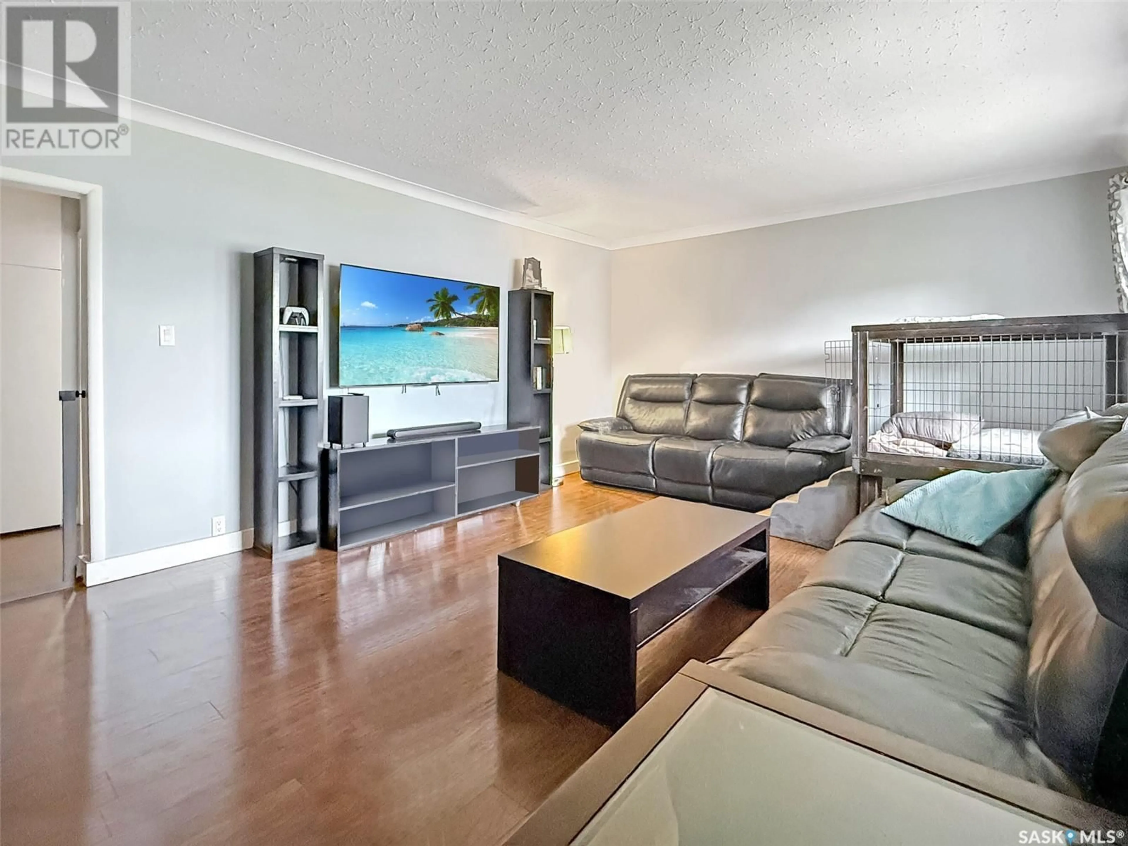Living room with furniture, wood/laminate floor for 325 3RD AVENUE, Swift Current Saskatchewan S9H2G8